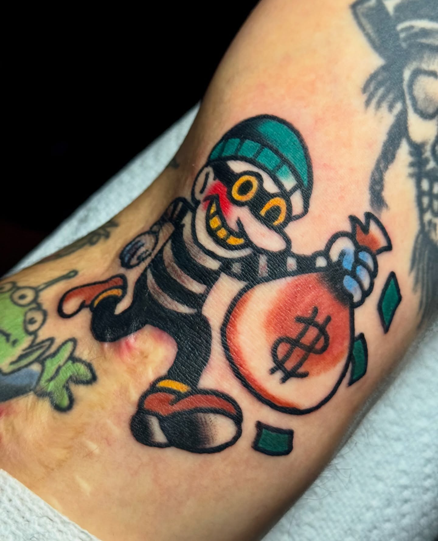 Robber with money bag American traditional tattoo on the forearm by Javin Klingelhoefer Mosley