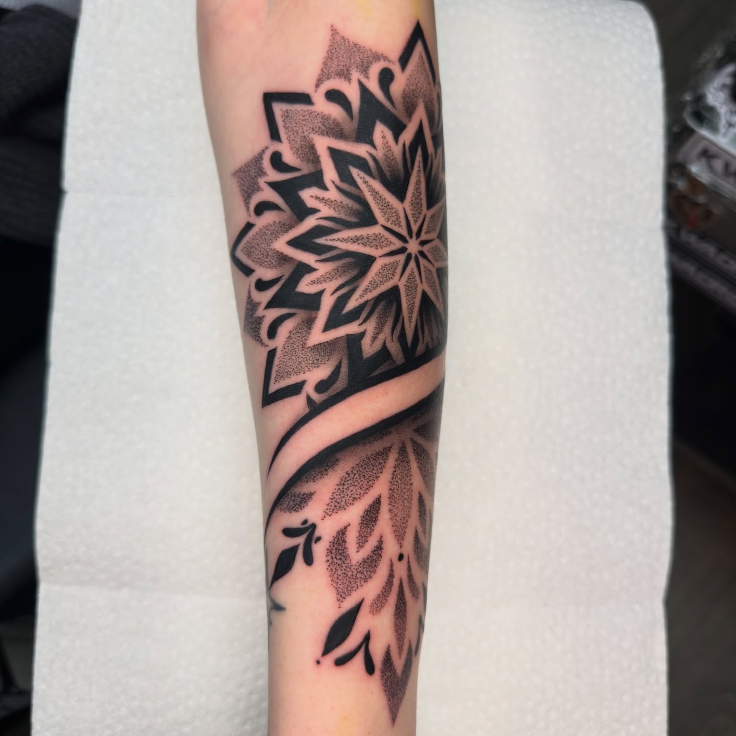 Geometric pattern dotwork tattoo on the forearm by Justin Hay
