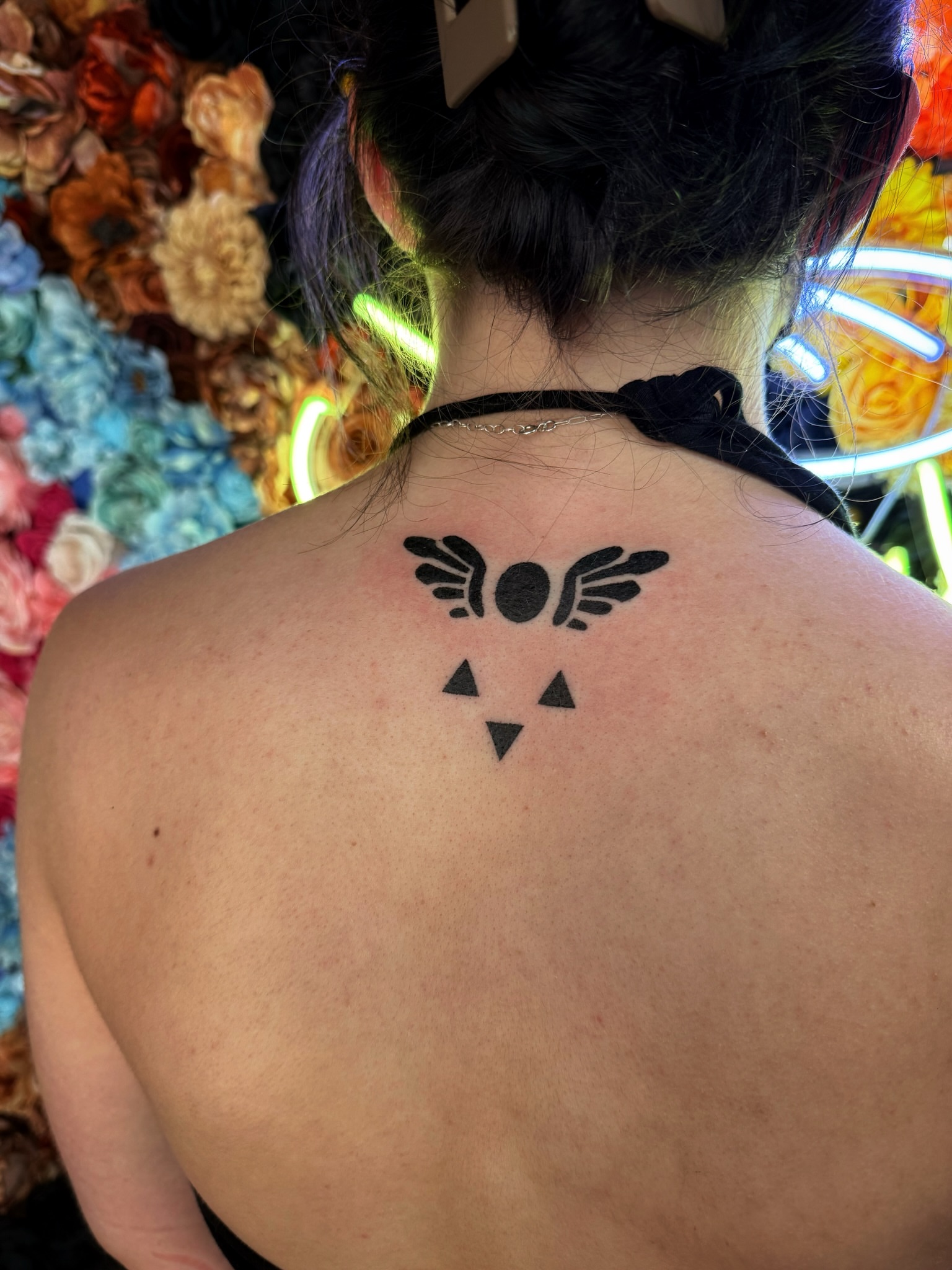 Bird wings and triangles geometric tattoo on the back by Handpoke Tattoo Artist, Minneapolis, Minnesota