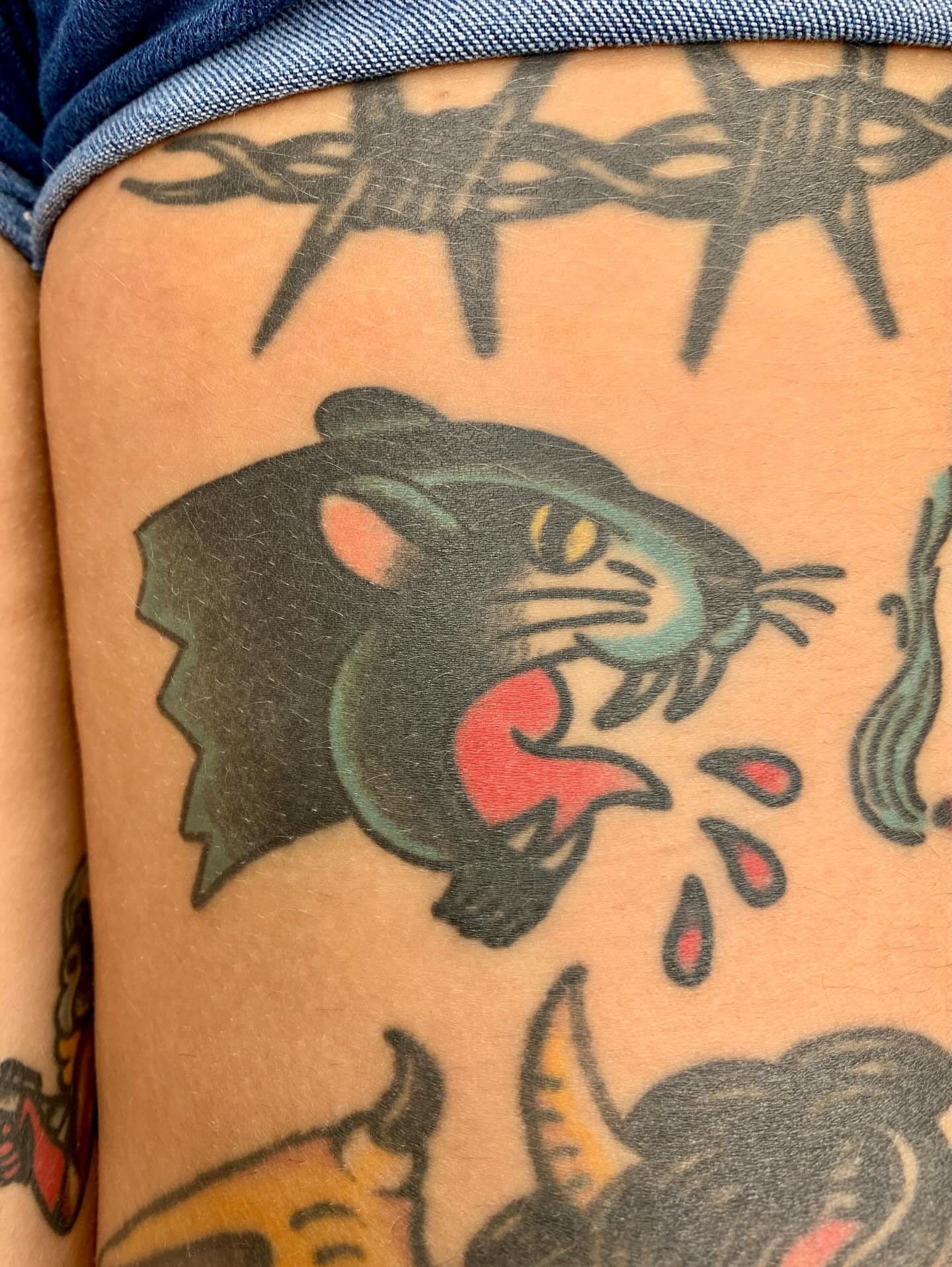Panther American traditional tattoo on the thigh by Keegan Bergen