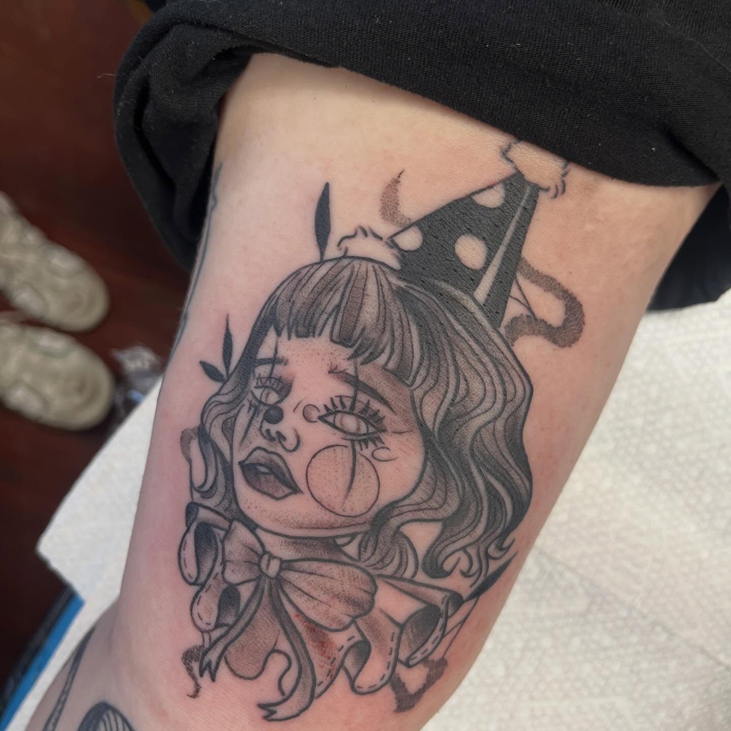 Doll black and grey tattoo on the thigh by Evan Voelker