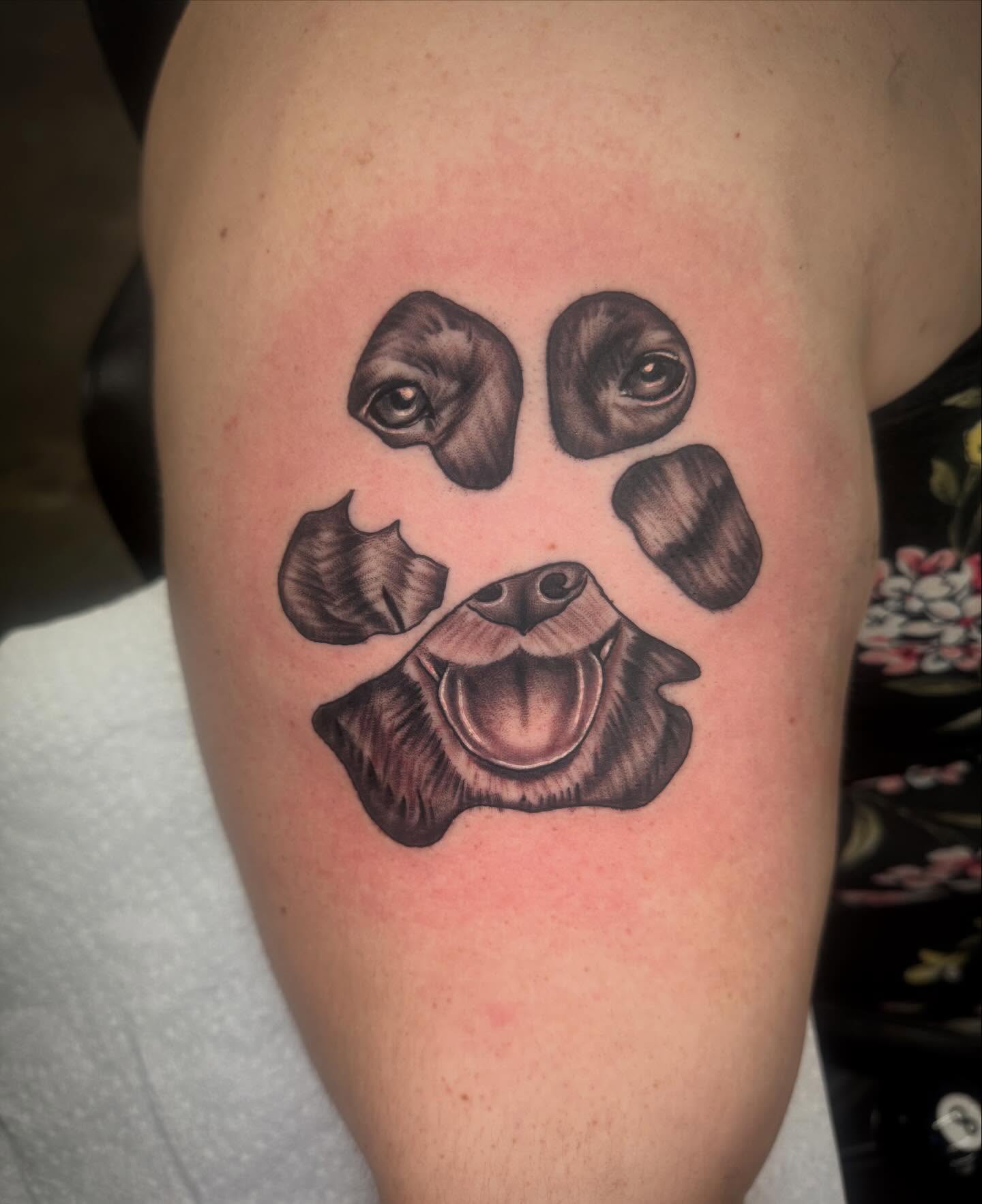 Dog paw print black and grey tattoo on the thigh by Jake Horstman, Dayton, Ohio