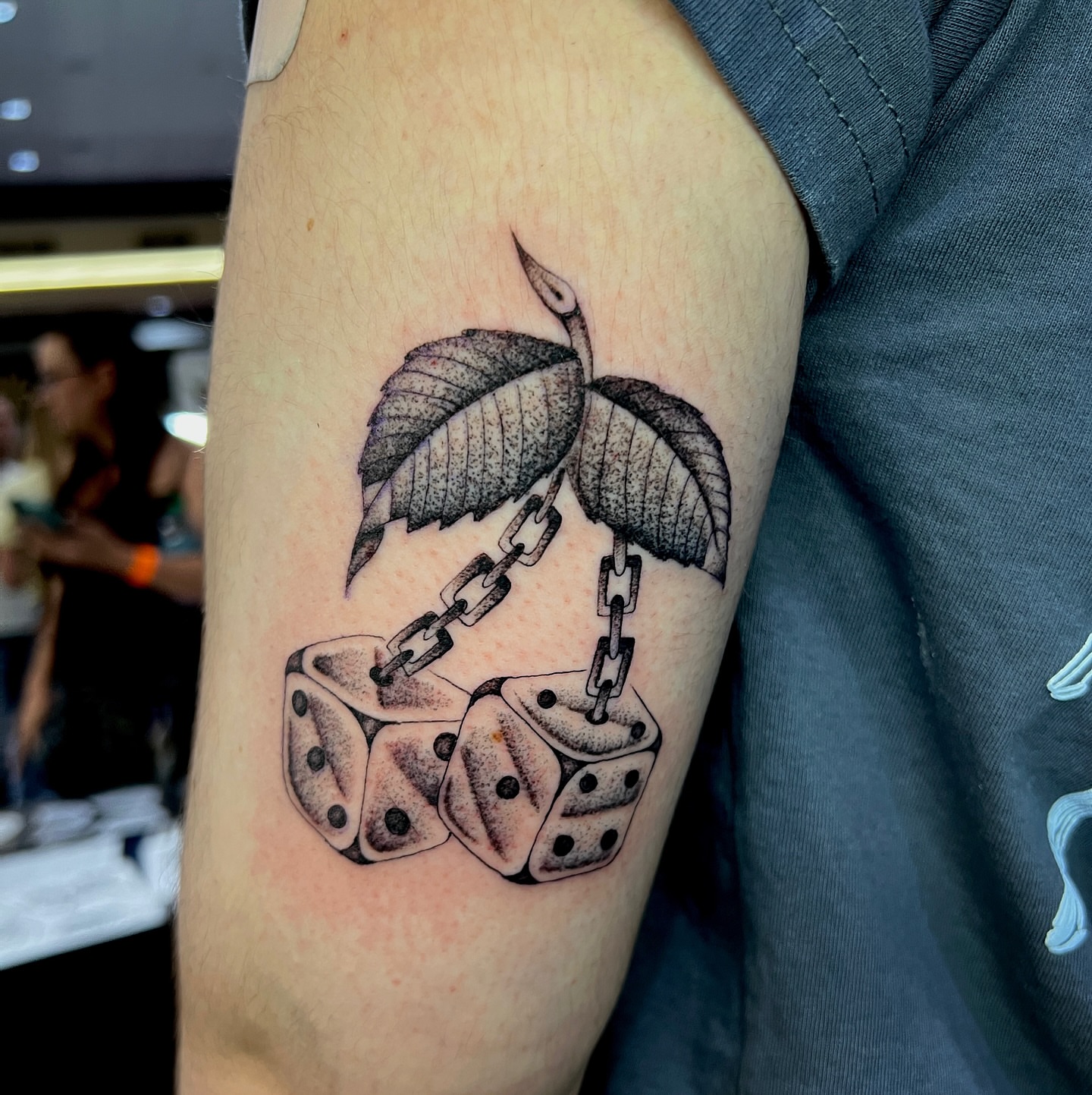 Dice and chain black and grey tattoo on the forearm by David Delacruz