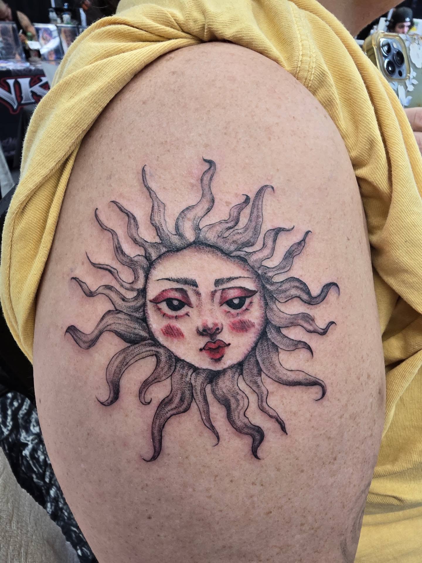 Sun face black and grey tattoo on the shoulder by Rachel, Centereach, New York