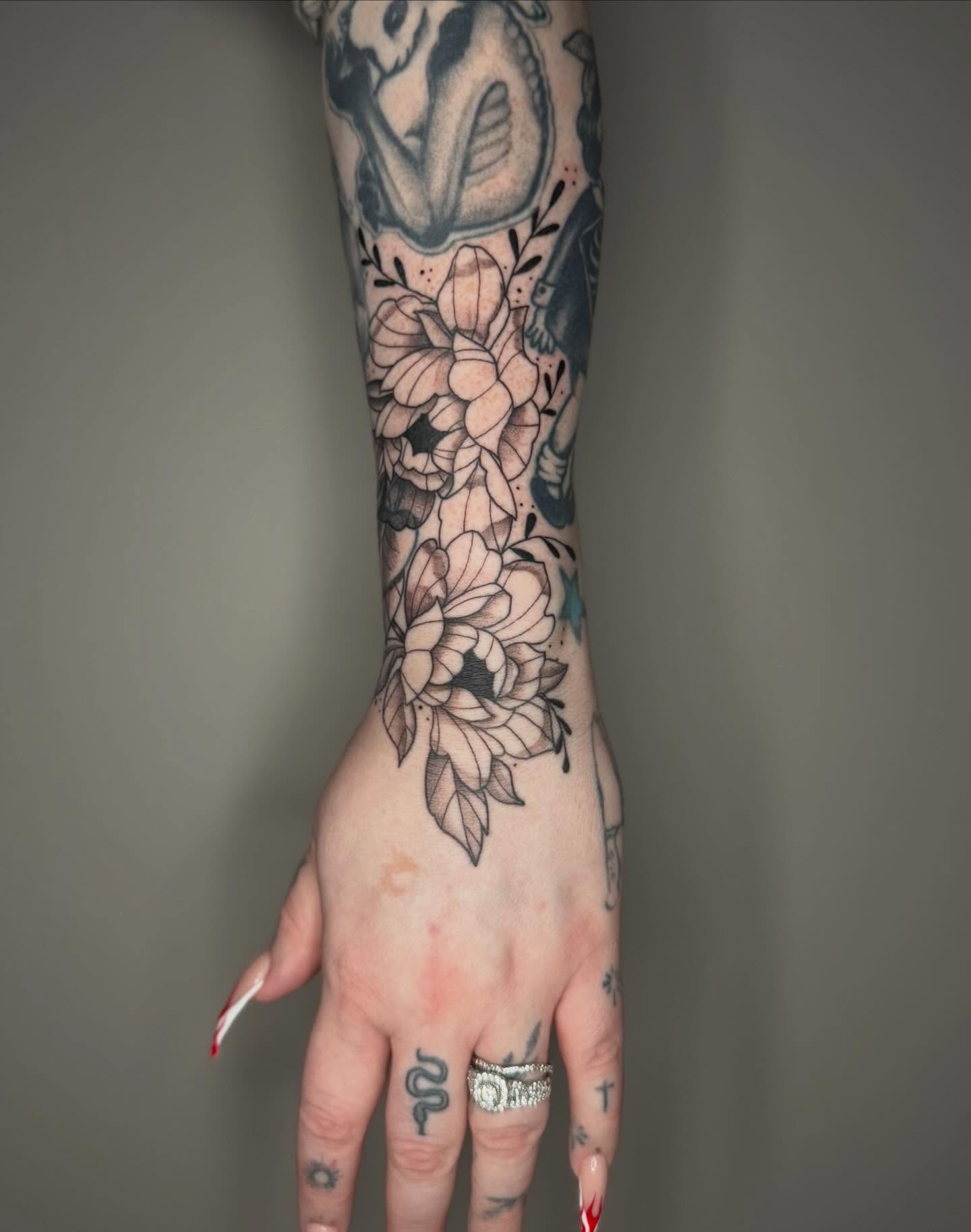 Floral bouquet geometric tattoo on the forearm by Brandi 🕷, Mentor, Ohio