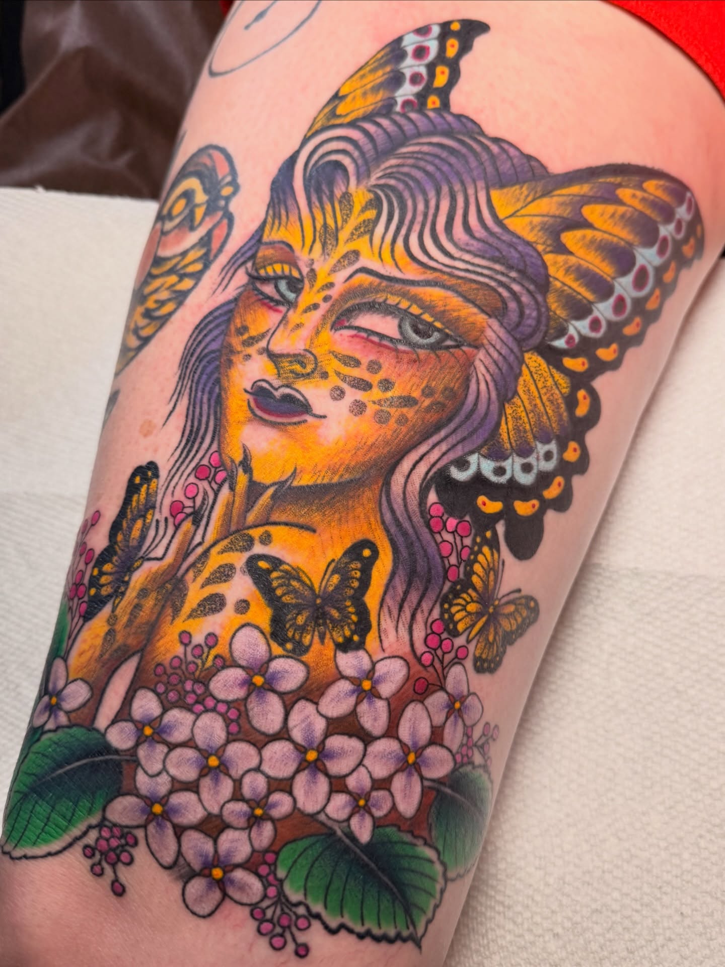Woman with butterflies American traditional tattoo on the thigh by Jhon