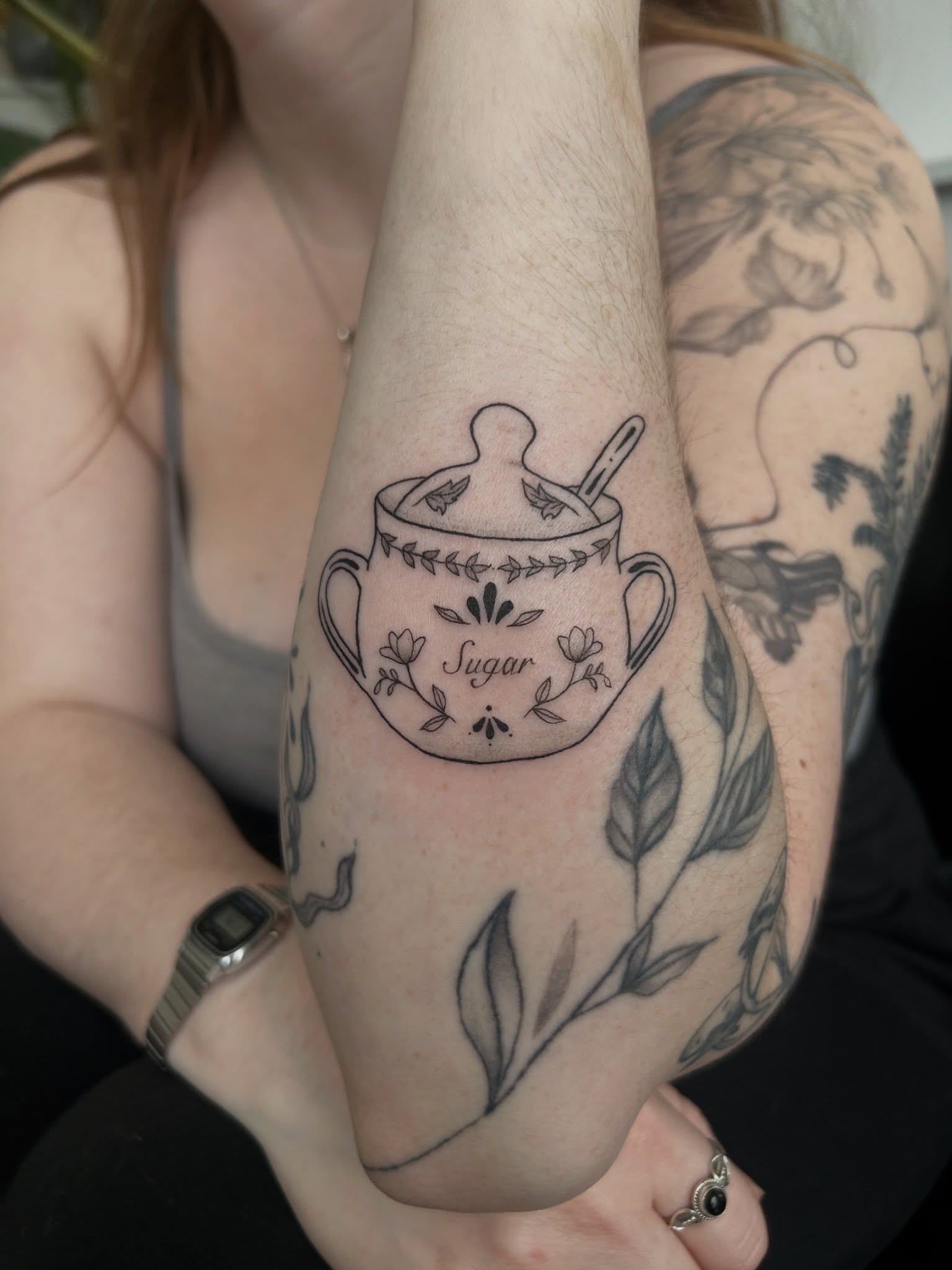 Teacup black and grey tattoo on the forearm by beth