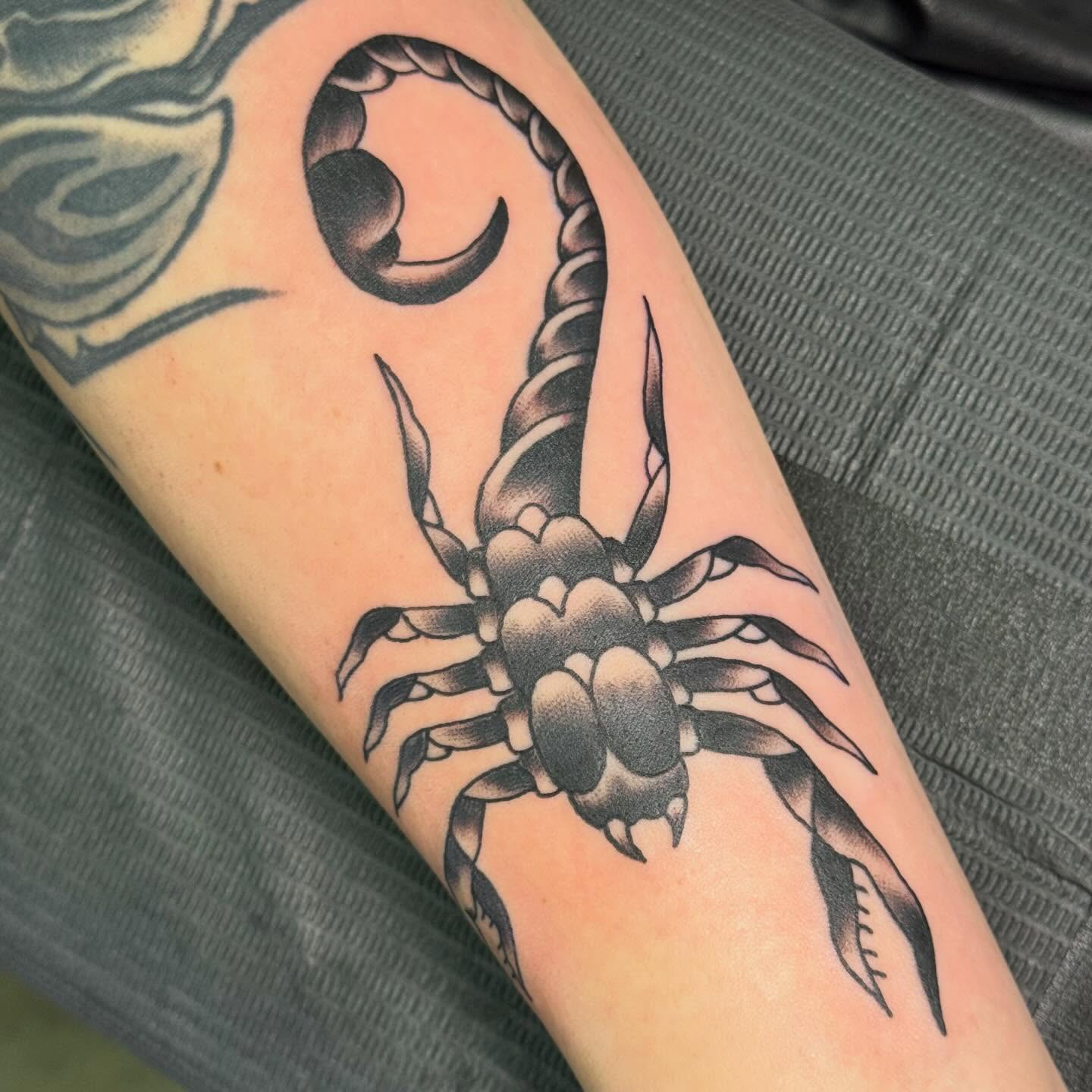 Scorpion black and grey tattoo on the forearm by Jack Hatchet Tattoos