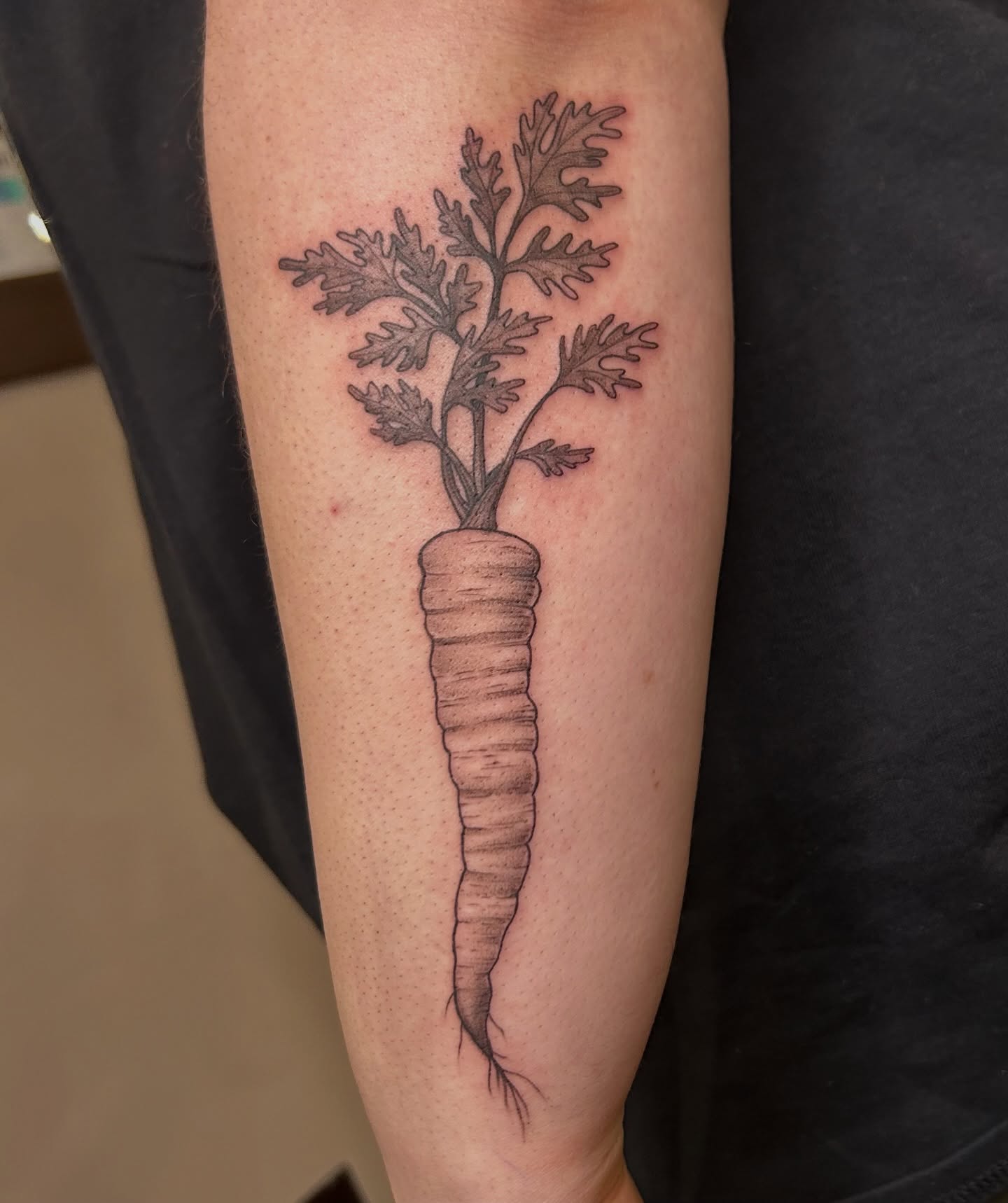 Carrot black and grey tattoo on the forearm by Kaylee