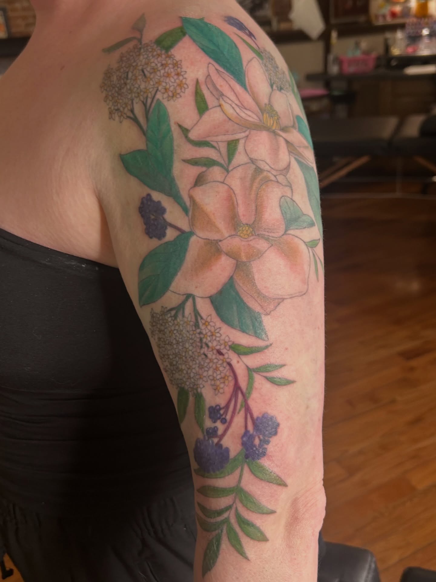 Floral arrangement realism tattoo on the forearm by Kaylee