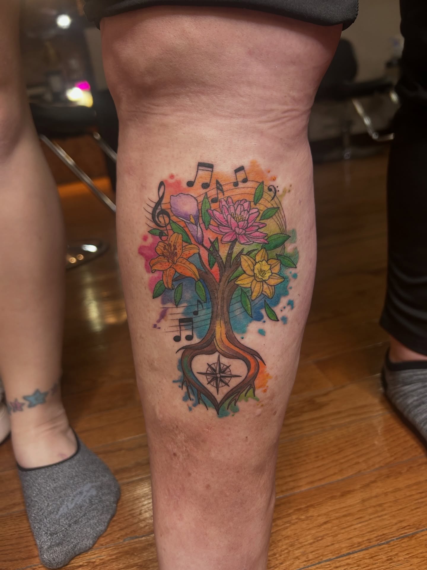 Music tree watercolor tattoo on the thigh by Kaylee