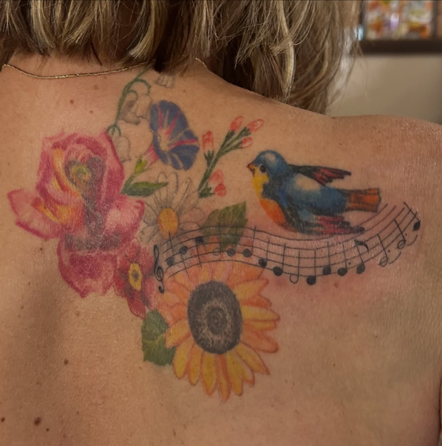 Bird and flowers new school tattoo on the back by Kaylee