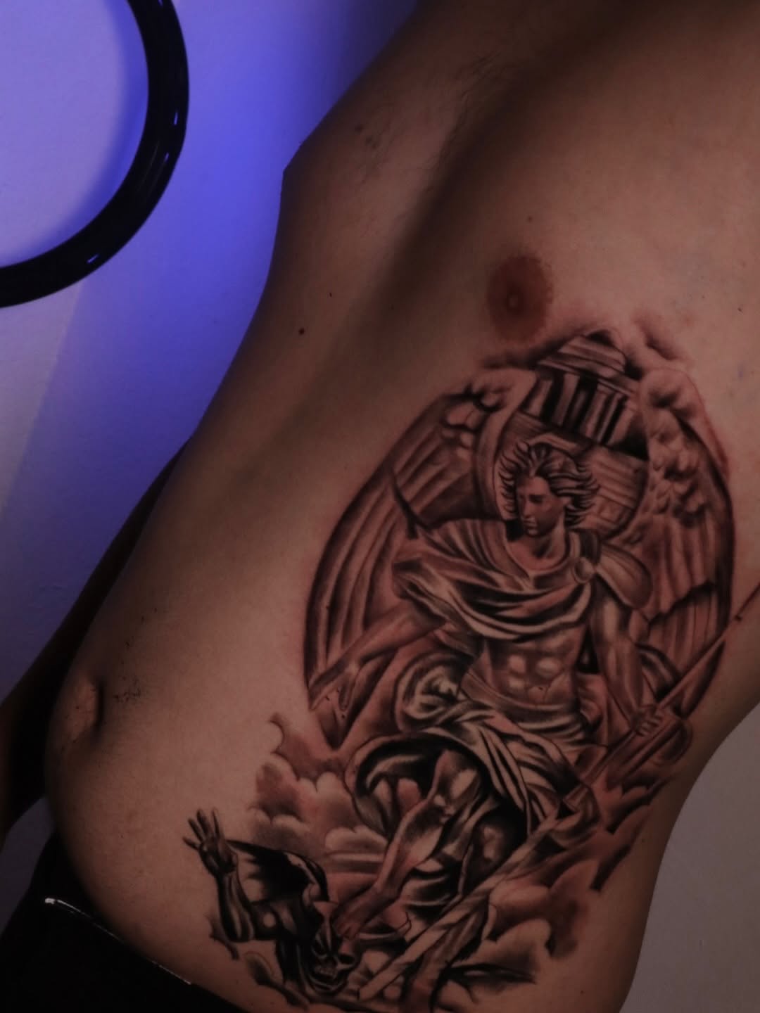 Archangel Michael fighting a demon realism tattoo on the ribs by Mr Letters🗡️