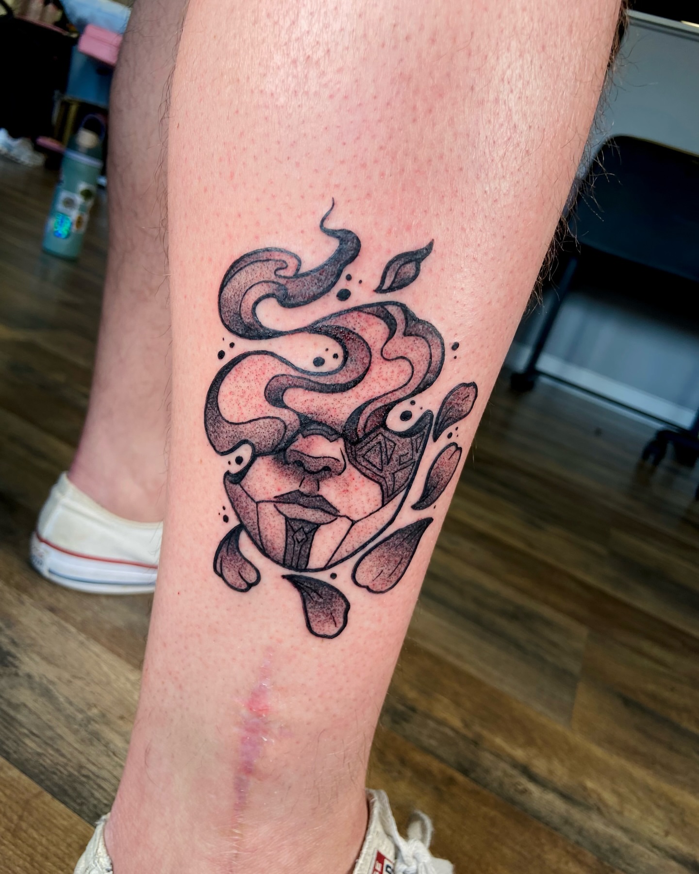 Abstract face dotwork tattoo on the forearm by Jezza Munson