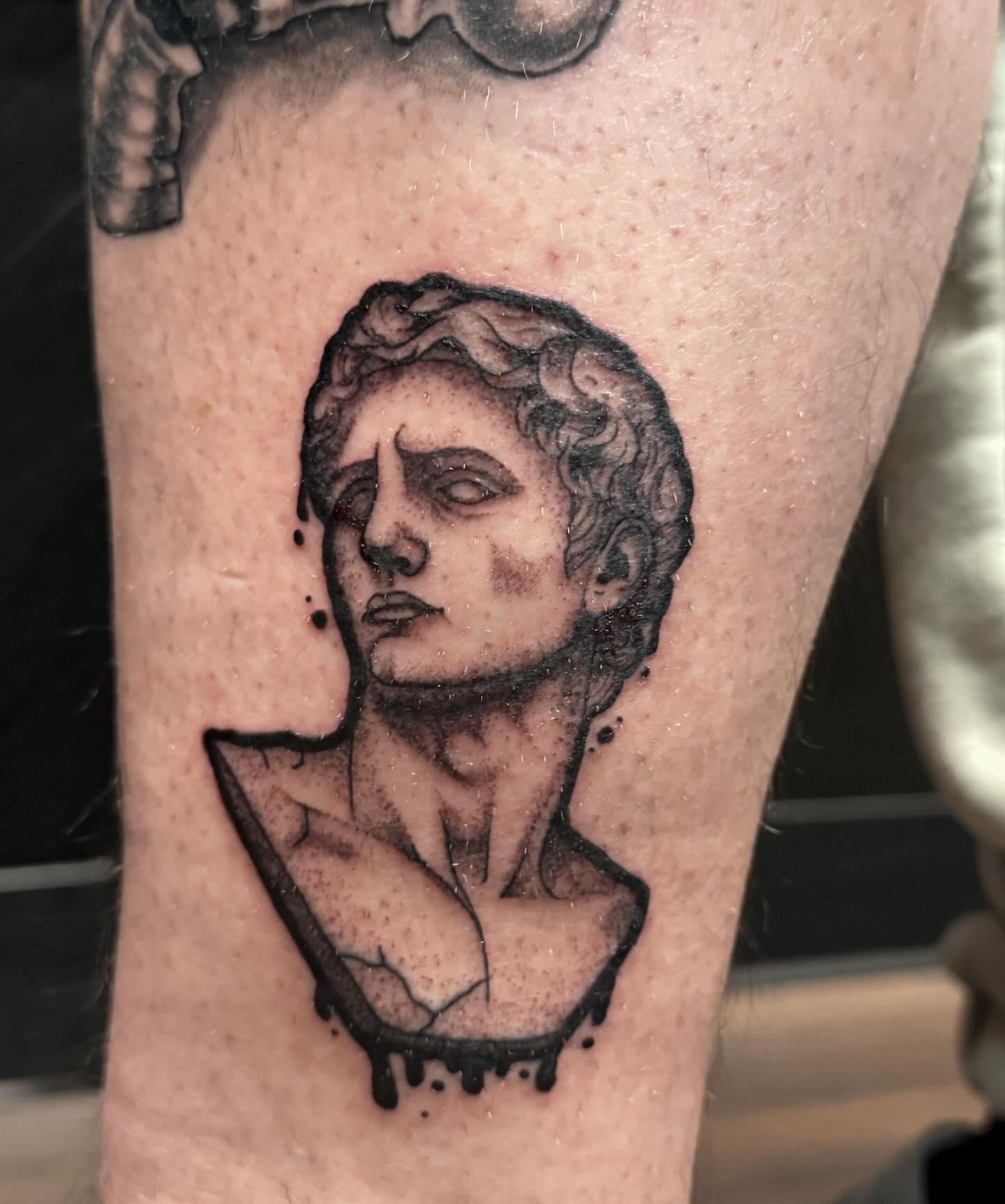 Statue bust black and grey tattoo on the forearm by Sebastián Vallejo