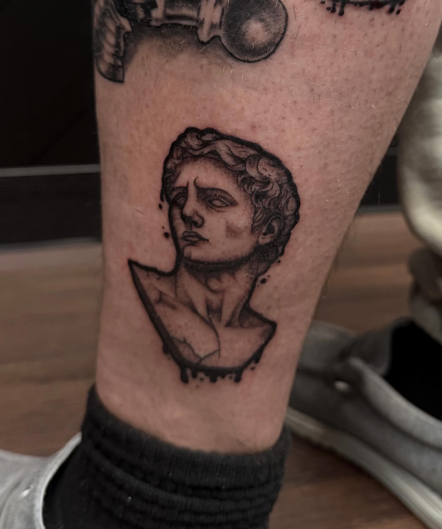 Statue bust black and grey tattoo on the forearm by Sebastián Vallejo
