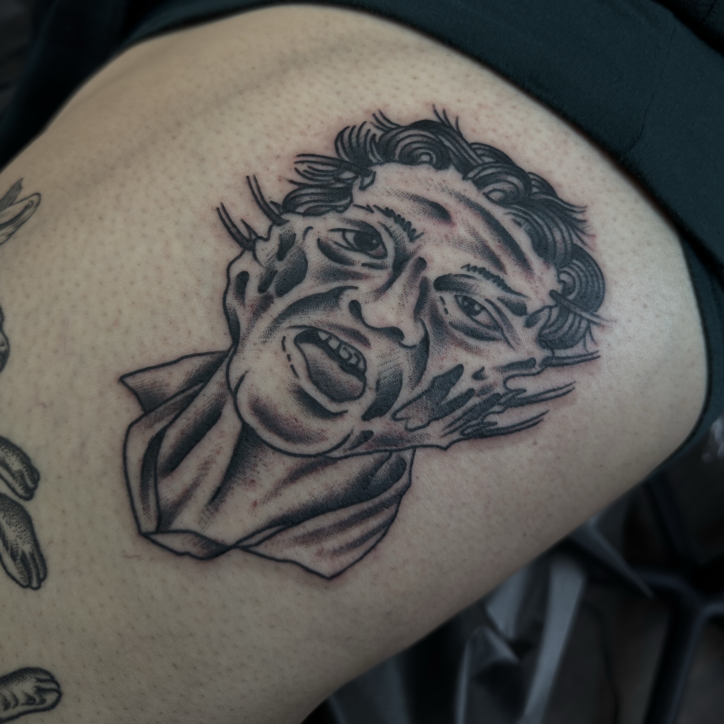 Angry face black and grey tattoo on the thigh by ⚔️Andreas Dolleschal⚔️