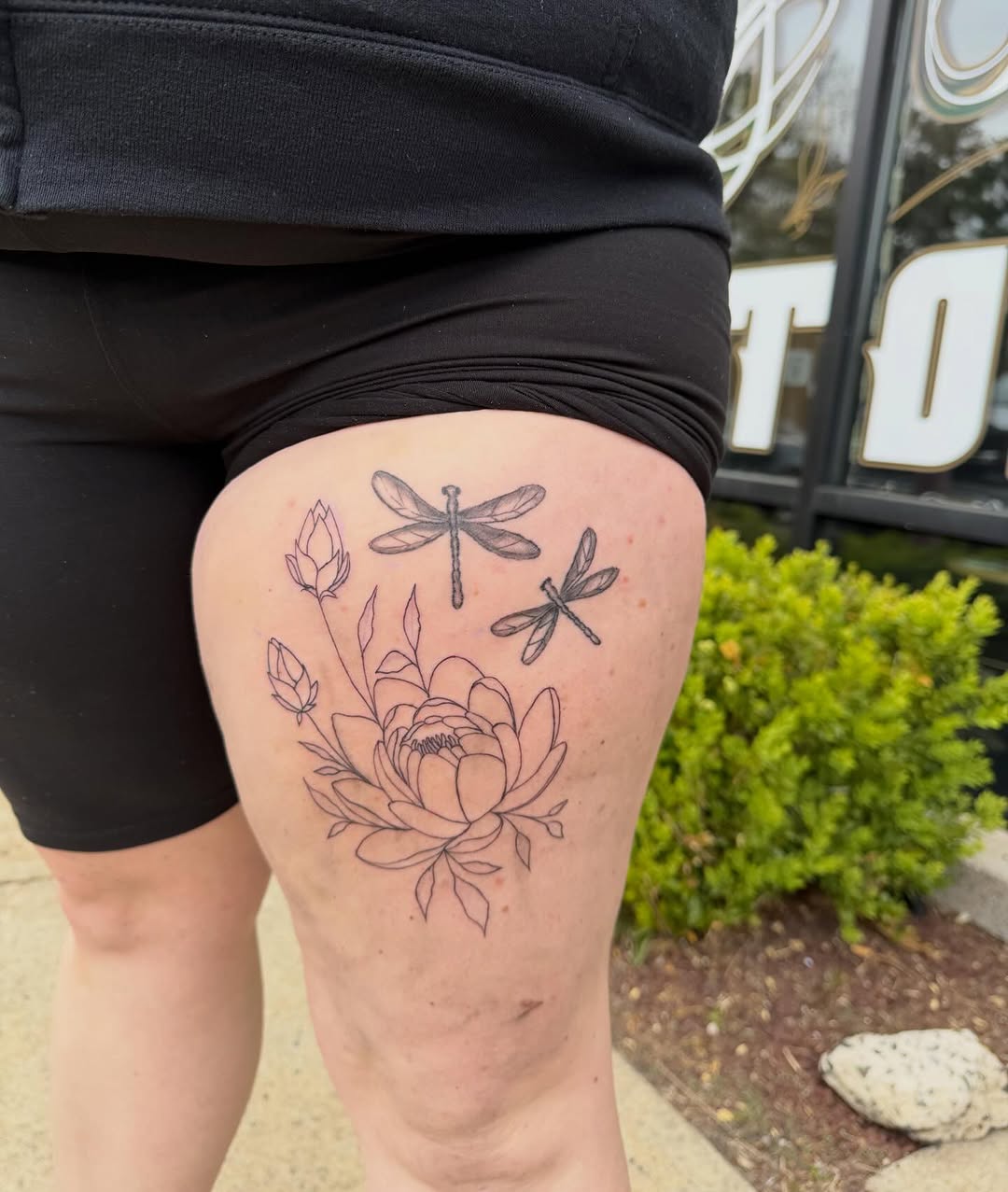 Dragonflies and peony fine line tattoo on the thigh by K. Bel Art