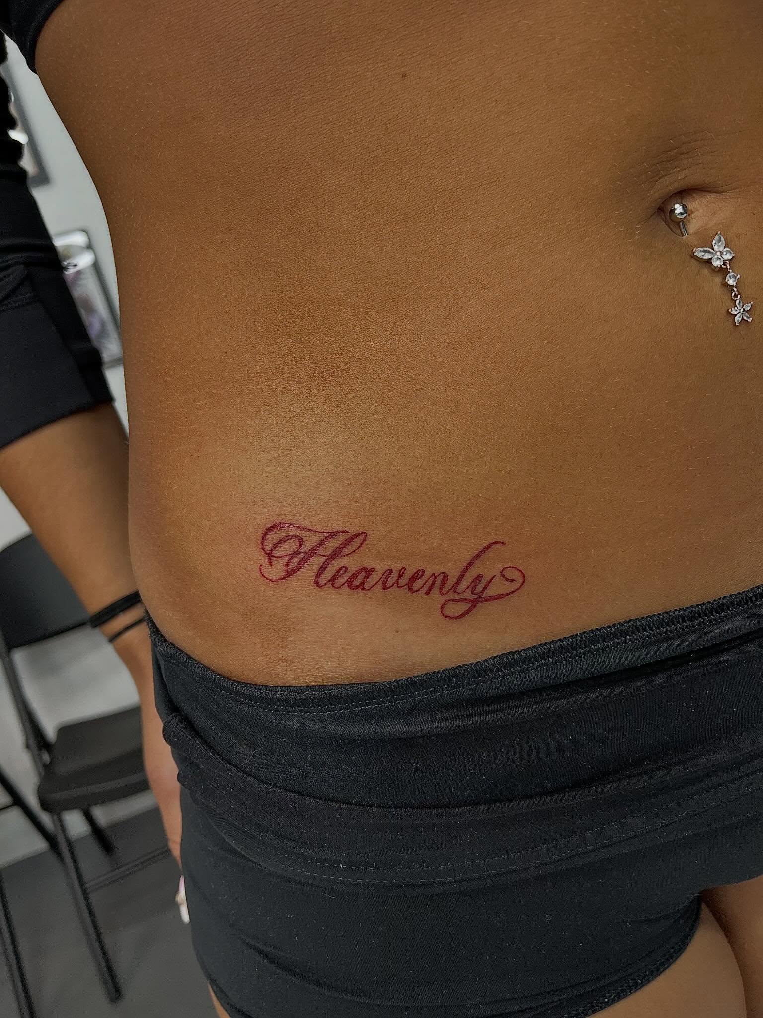 Heavenly lettering script tattoo on the torso by Mason McCubbin