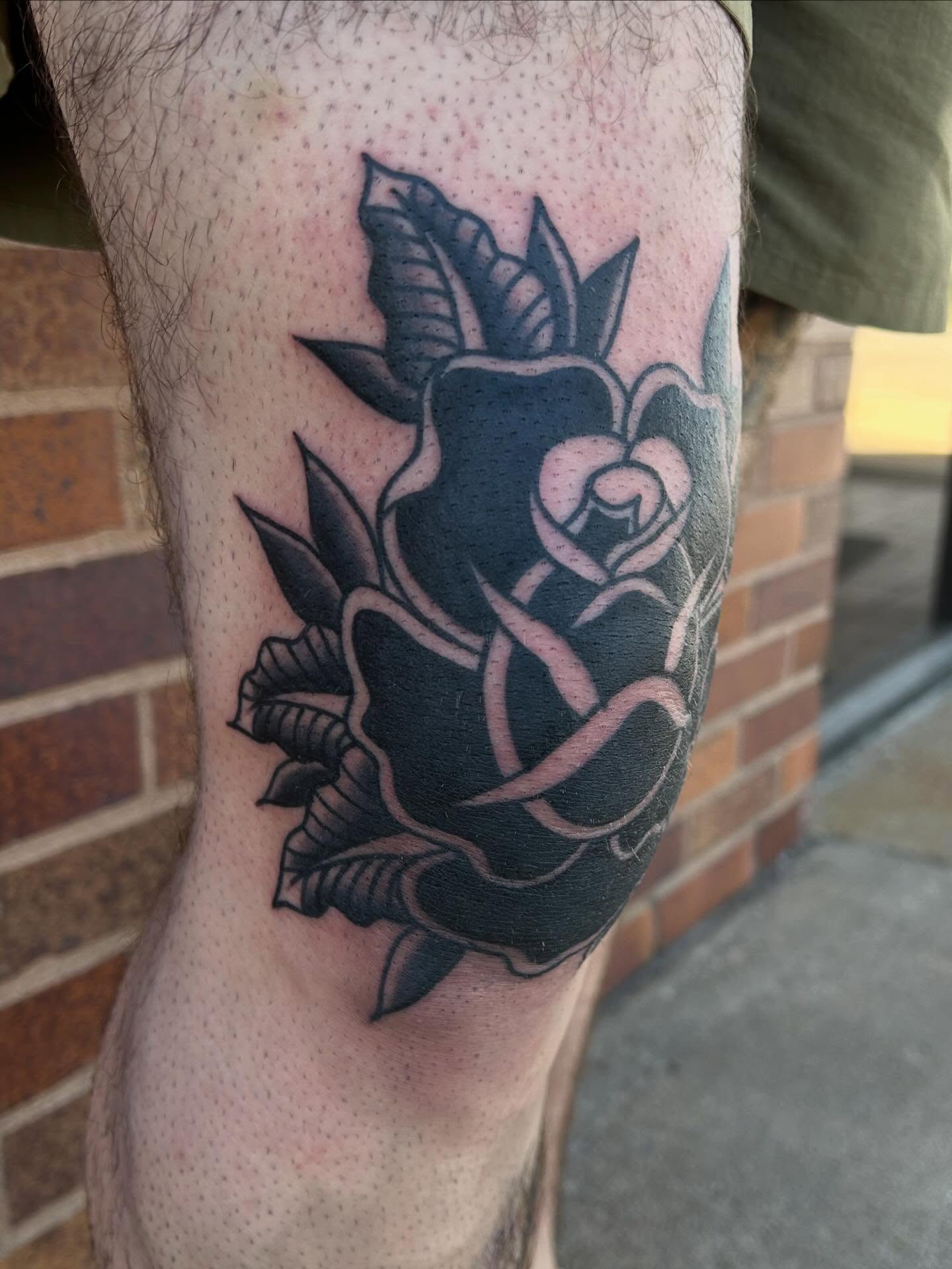Rose black and grey tattoo on the thigh by Morgan Hazer Tattoos, Cedar Rapids, Iowa