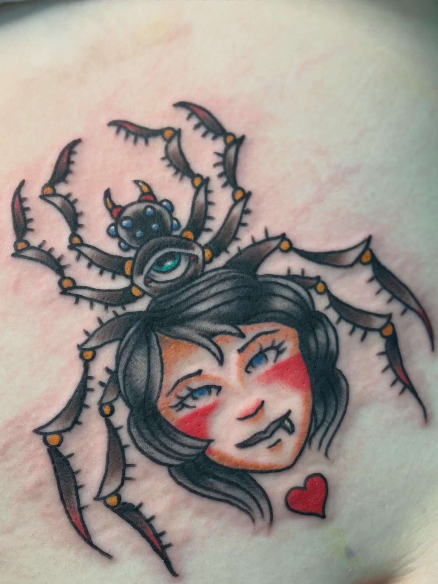 Woman with spider American traditional tattoo on the chest by Nick Tate