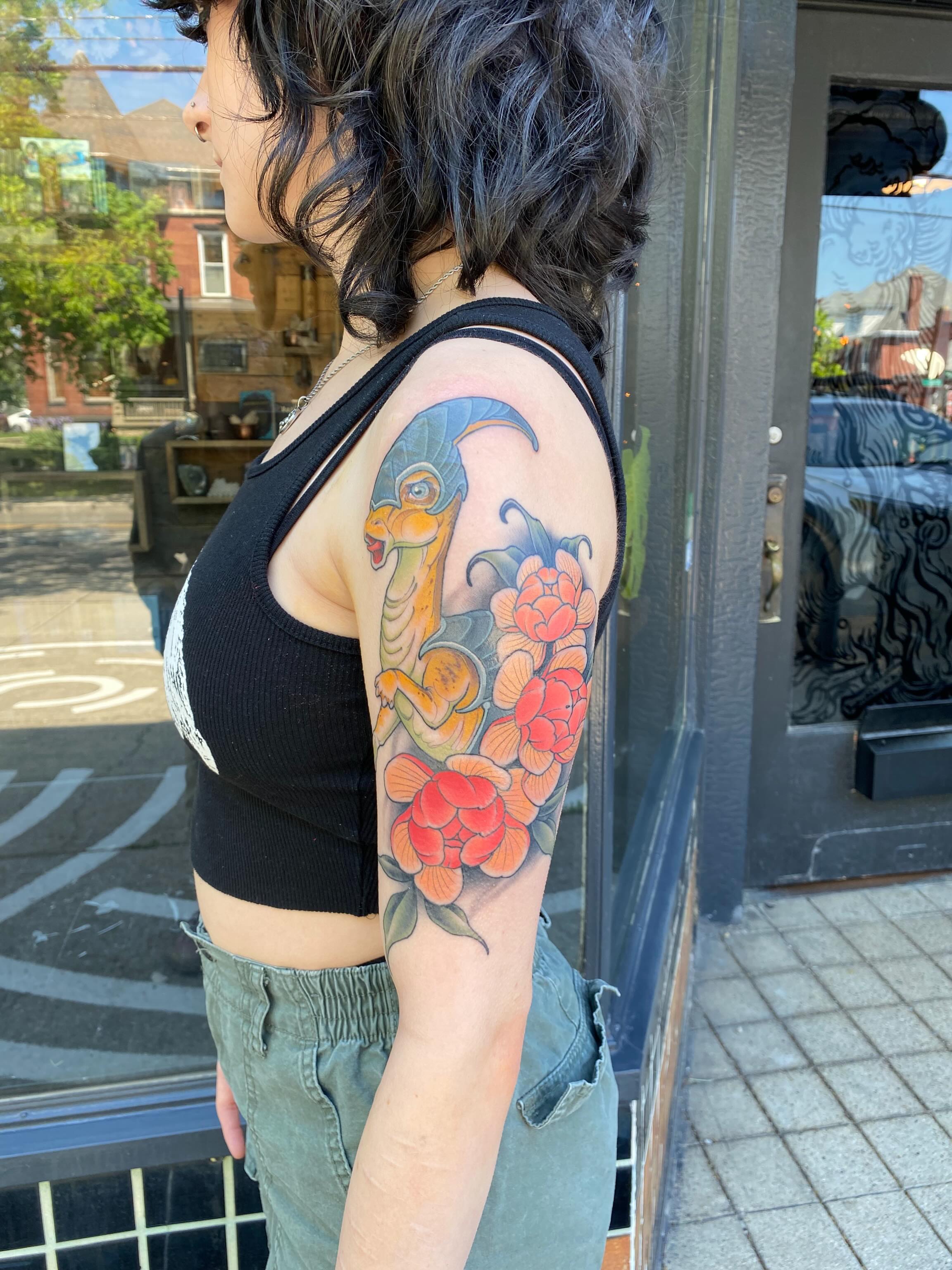 Snake and peony American traditional tattoo on the upper arm by Kyle Kozek, Columbus, Ohio