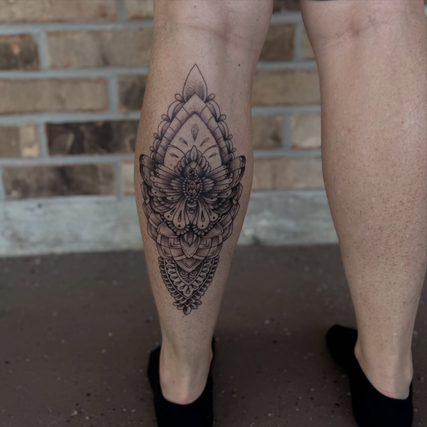 Mandala black and grey tattoo on the calf by Storm