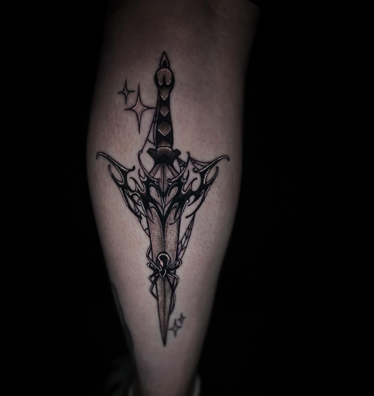 Sword black and grey tattoo on the forearm by Angie Milano