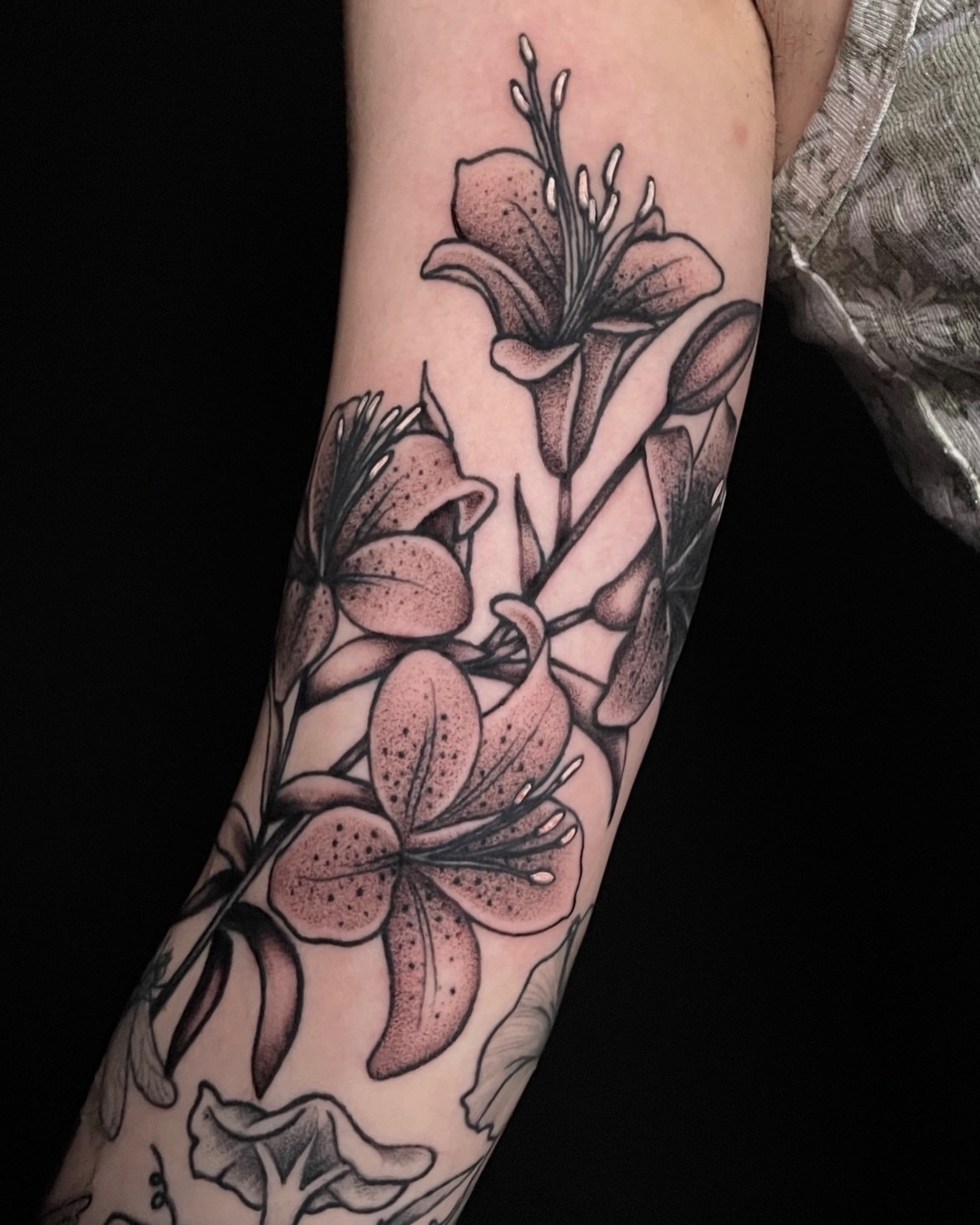 Lilies dotwork tattoo on the forearm by Austin Clark