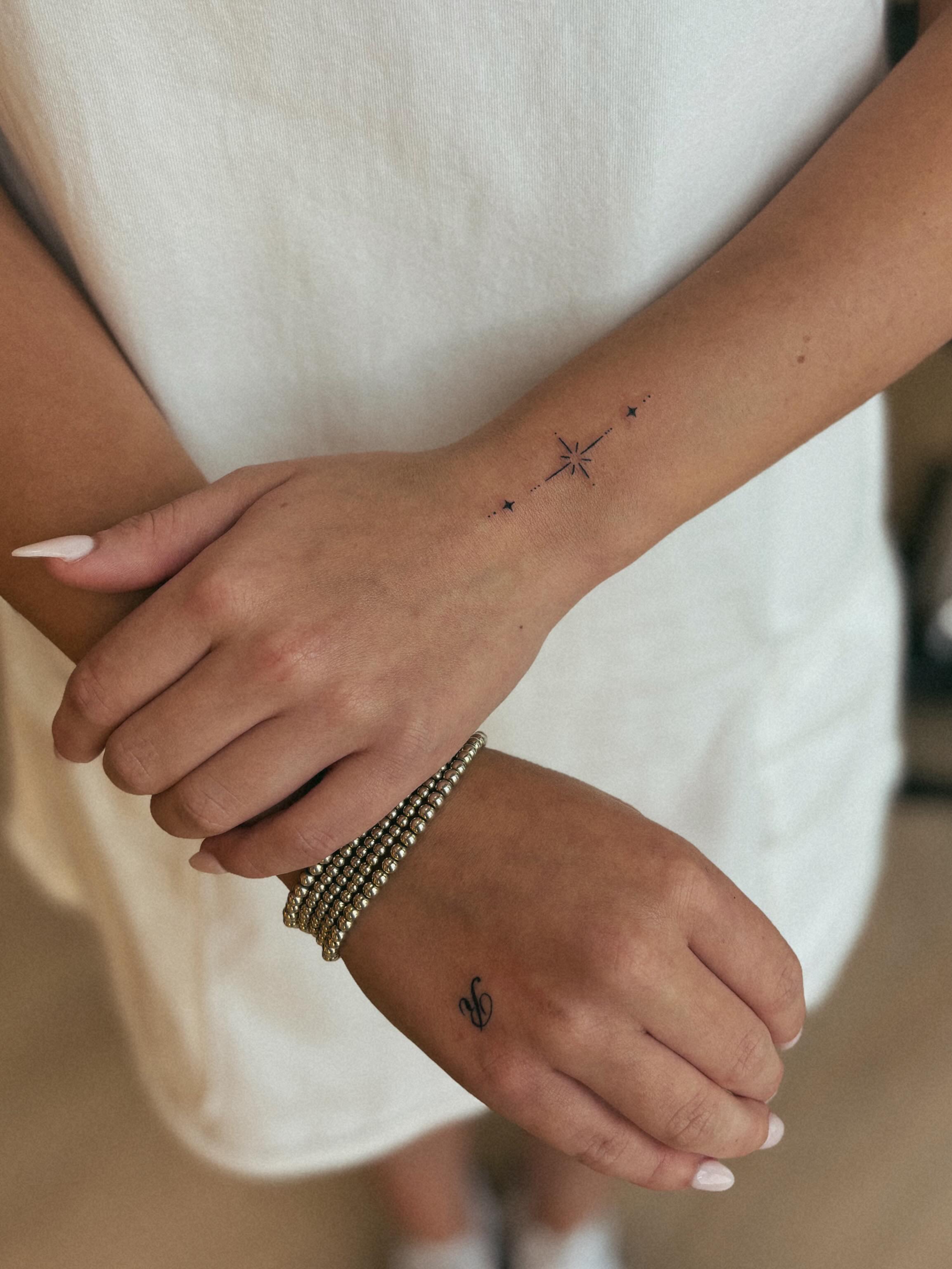 Star and line fine line tattoo on the forearm by Allie