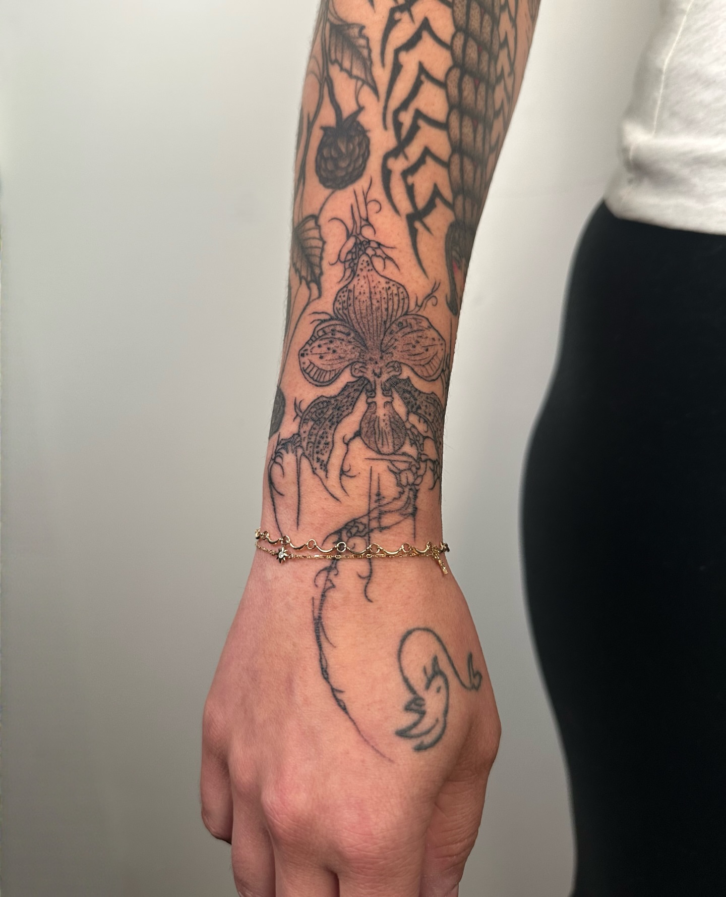 Iris and hand black and grey tattoo on the forearm by Brooklyn Bailey