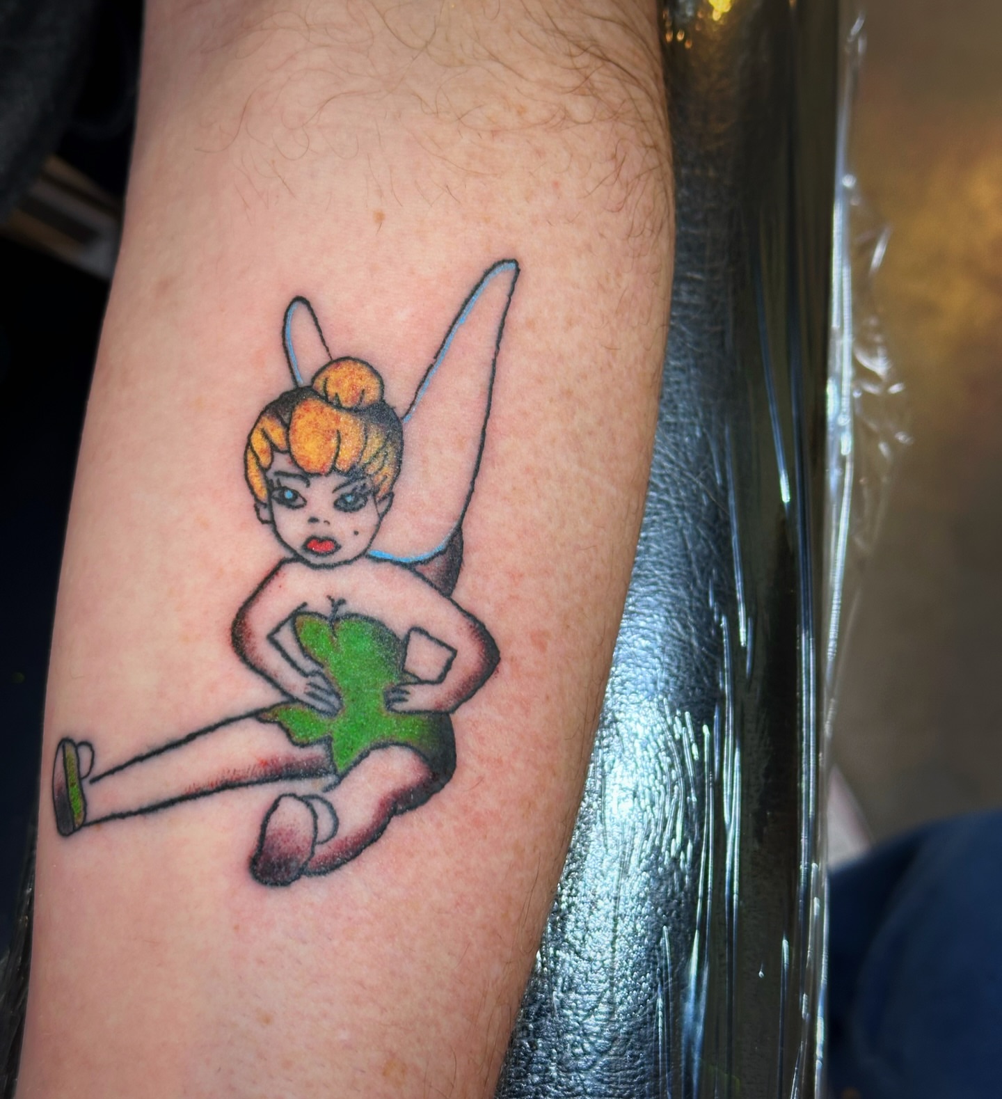 Tinker Bell illustrative tattoo on the forearm by Madeline Seeley