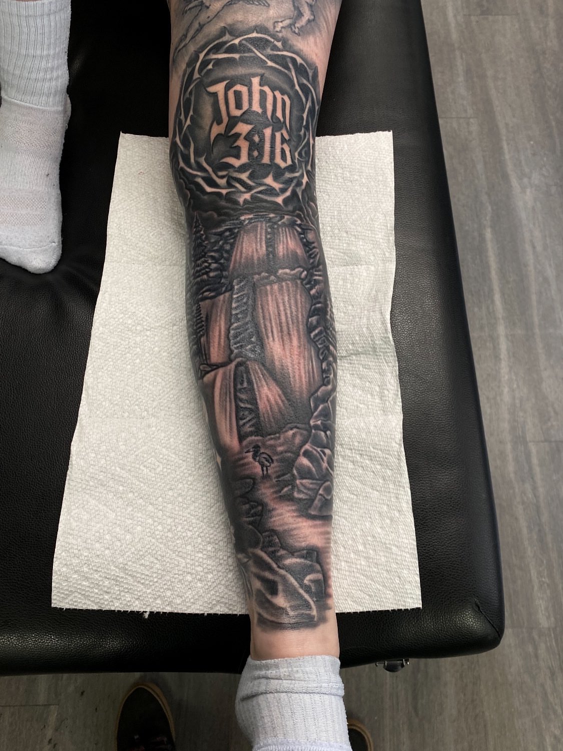 Religious verse black and grey tattoo on the forearm by Kelan Mckenna