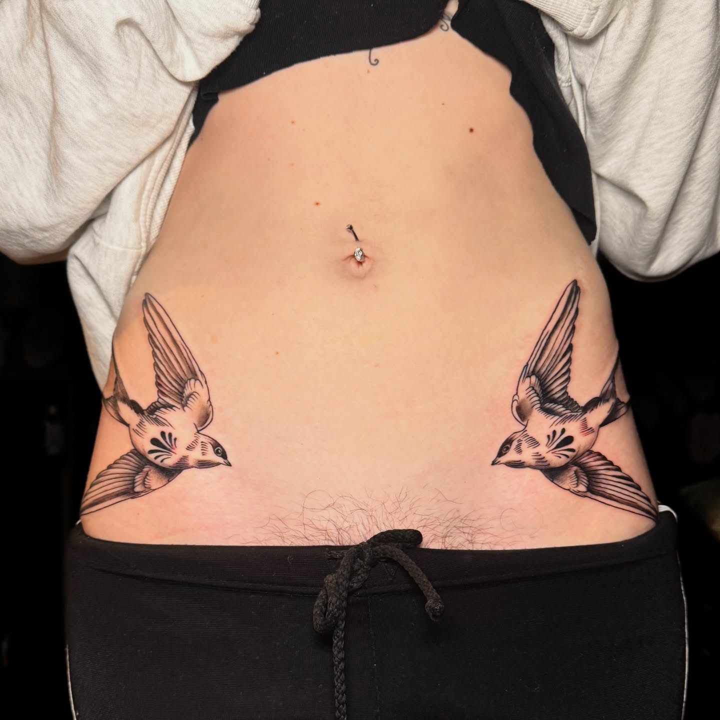 Swallows black and grey tattoo on the torso by Matthew - Tattoo Artist