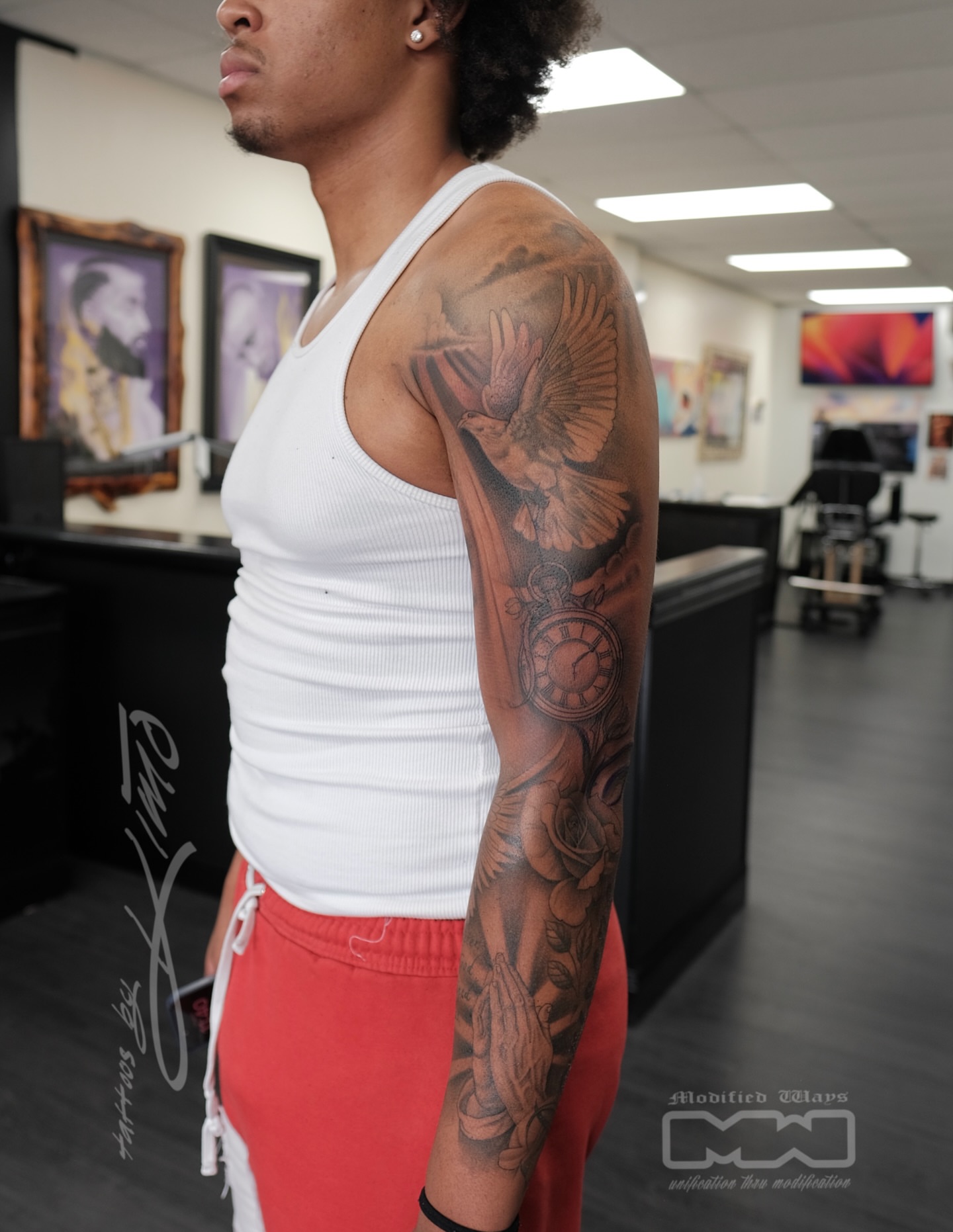 Bird and clock American traditional tattoo on the upper arm by Kansas City tattoo artist