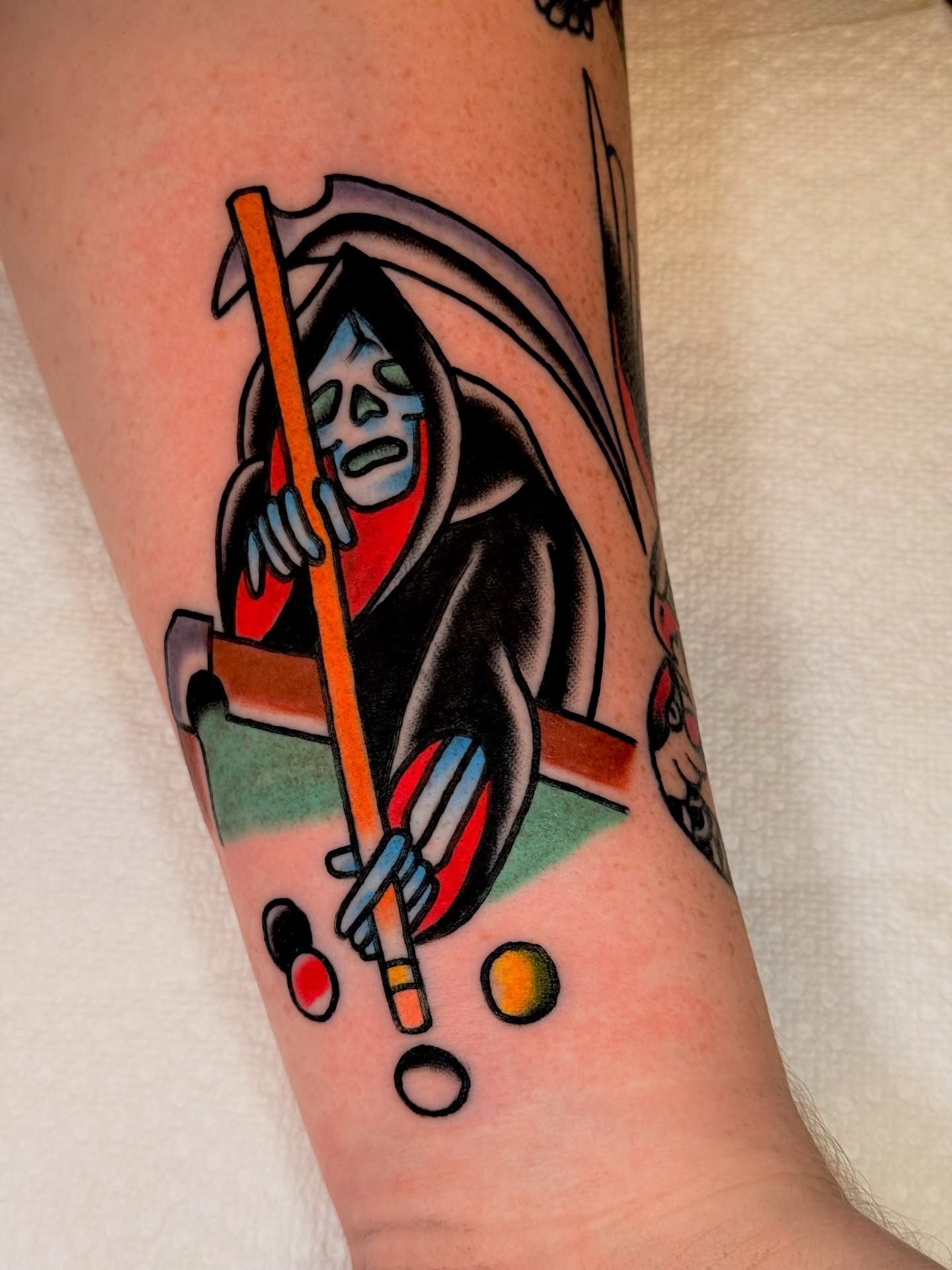 Reaper playing pool American traditional tattoo on the forearm by {{Theo Glanton}}
