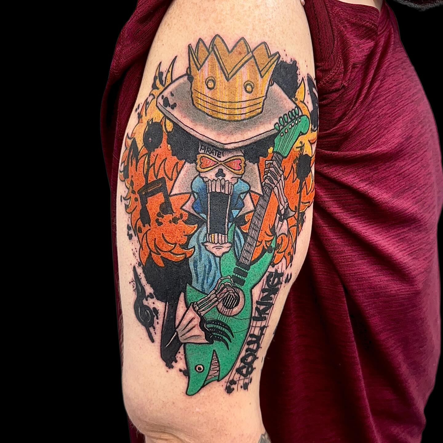 Pirate skeleton playing guitar American traditional tattoo on the forearm by Abby Ash, Belington, West Virginia