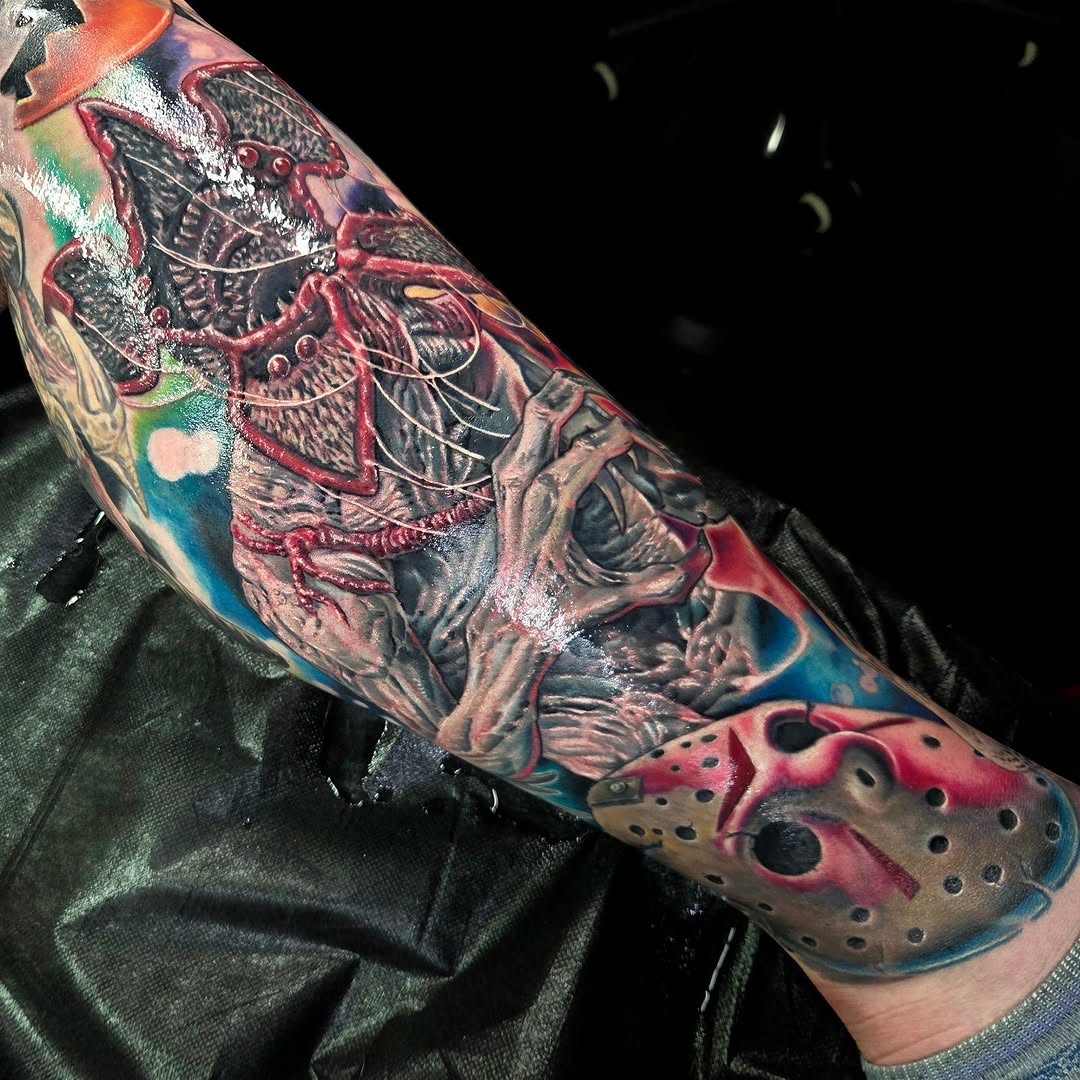 Demogorgon and Jason Voorhees mask realism tattoo on the forearm by Jake Goss, Salt Lake City, Utah