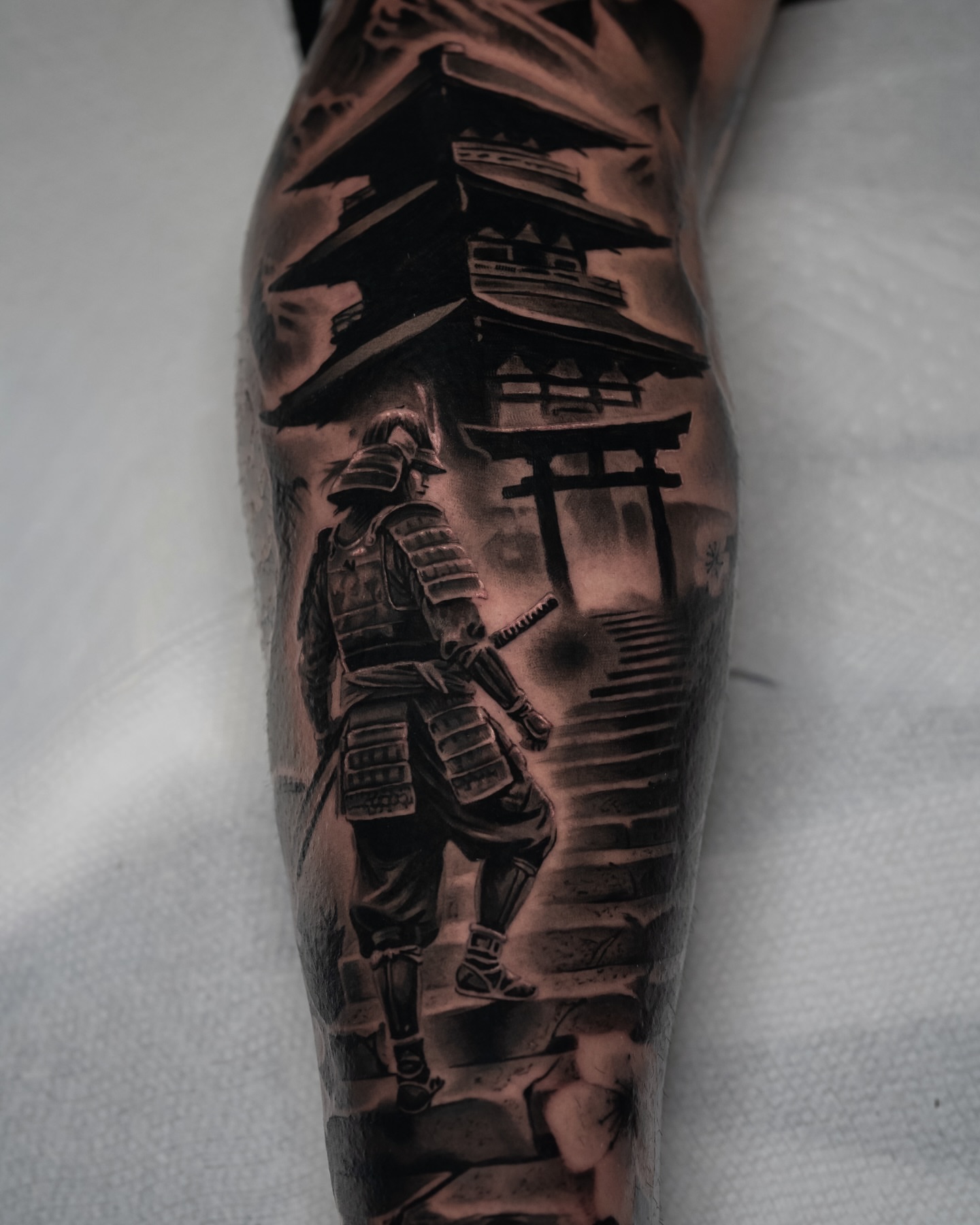 Samurai and torii gate realism tattoo on the forearm by Javier Chavez