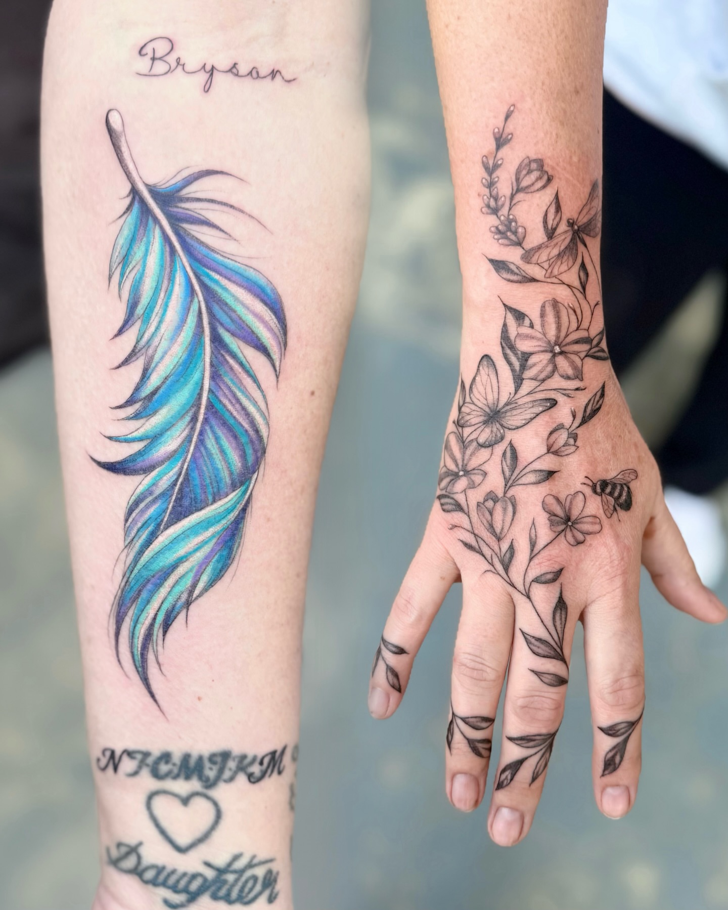 Feather and floral hand realism tattoo on the hand by Maggie George