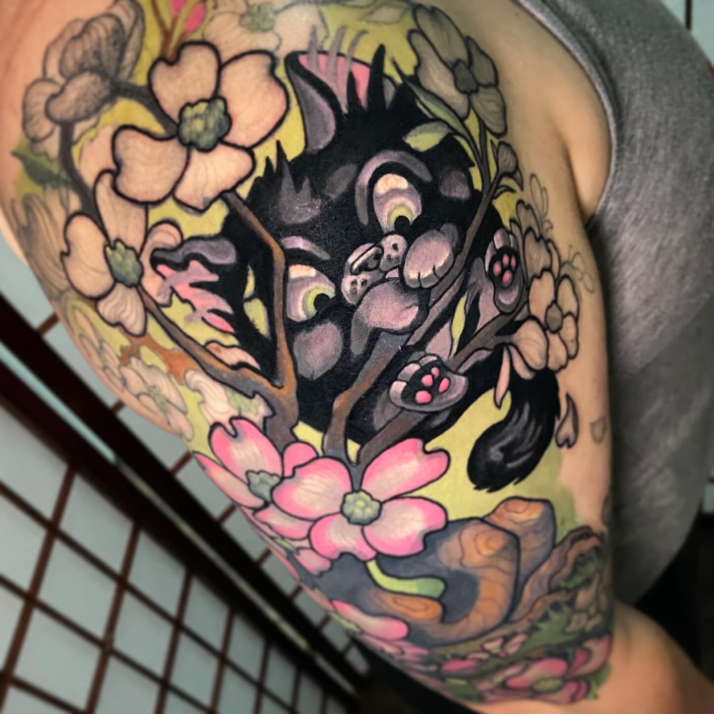 Cat and blossoms American traditional tattoo on the shoulder by Lindsay Hall