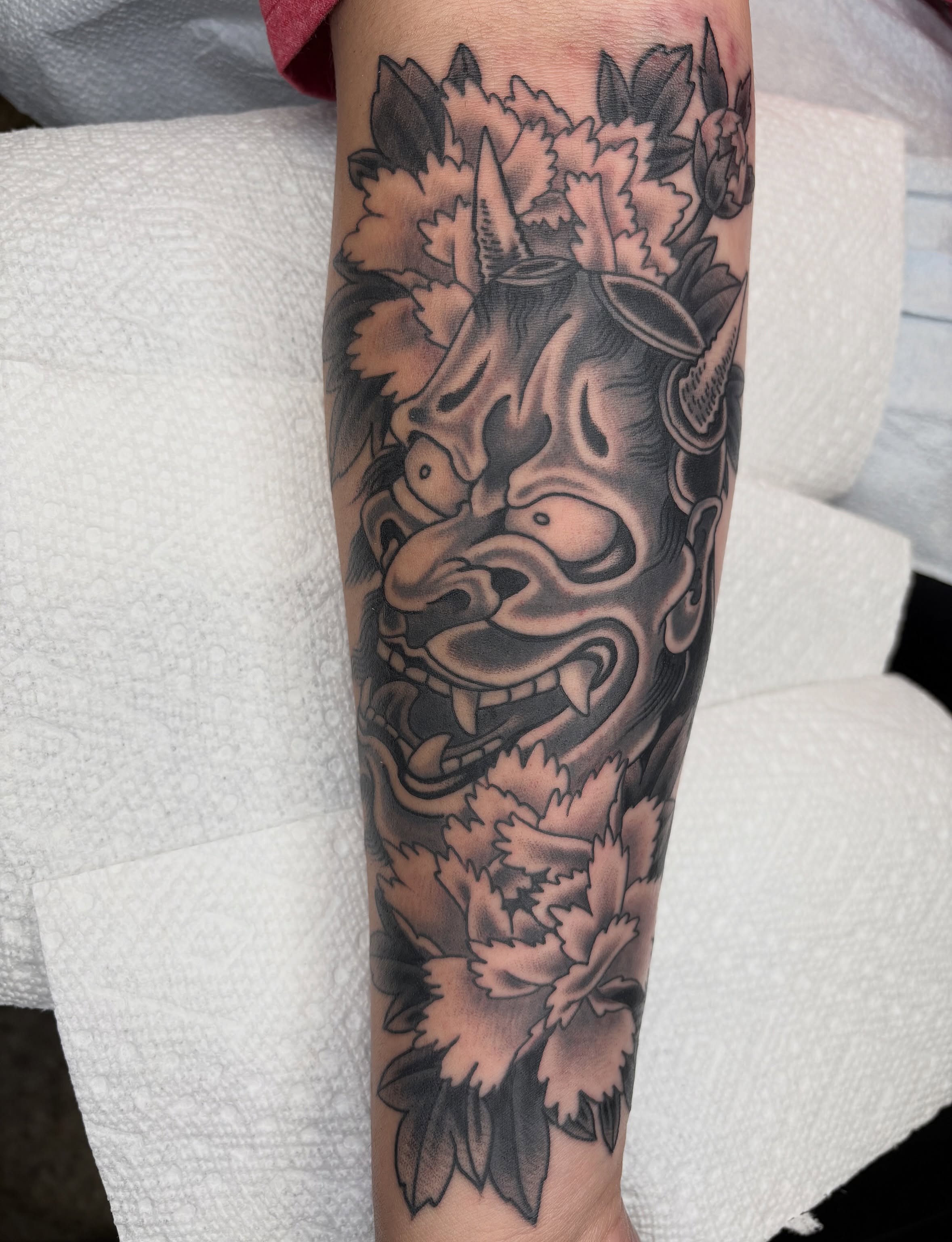 Mask with floral elements japanese irezumi tattoo on the forearm by Dallas Tattoo Artist