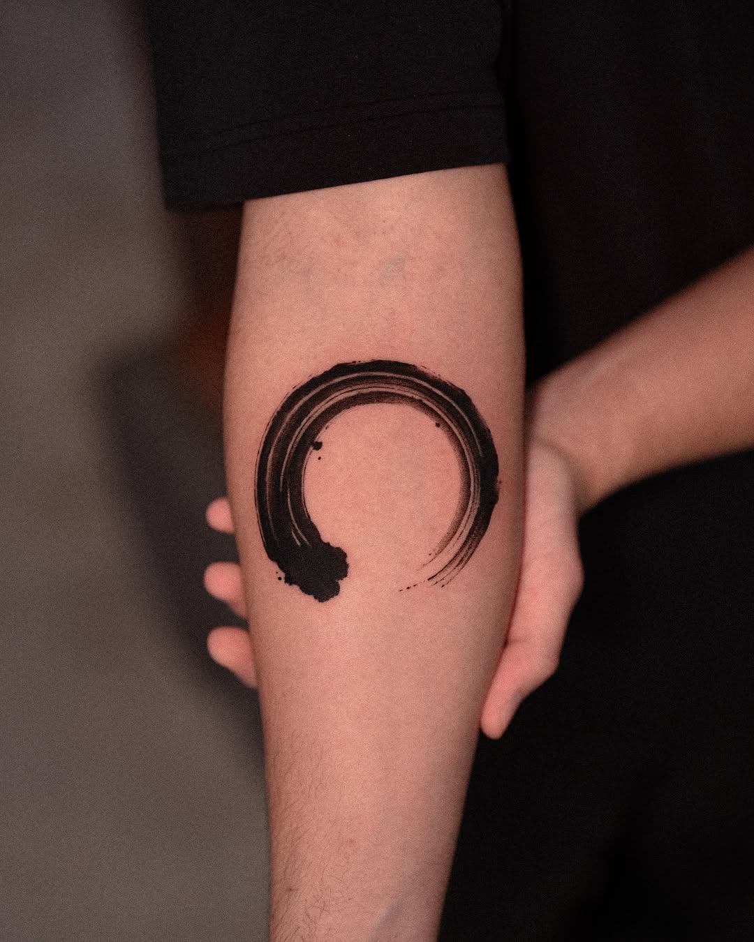 Enso circle surrealism tattoo on the forearm by Low, Brooklyn, New York