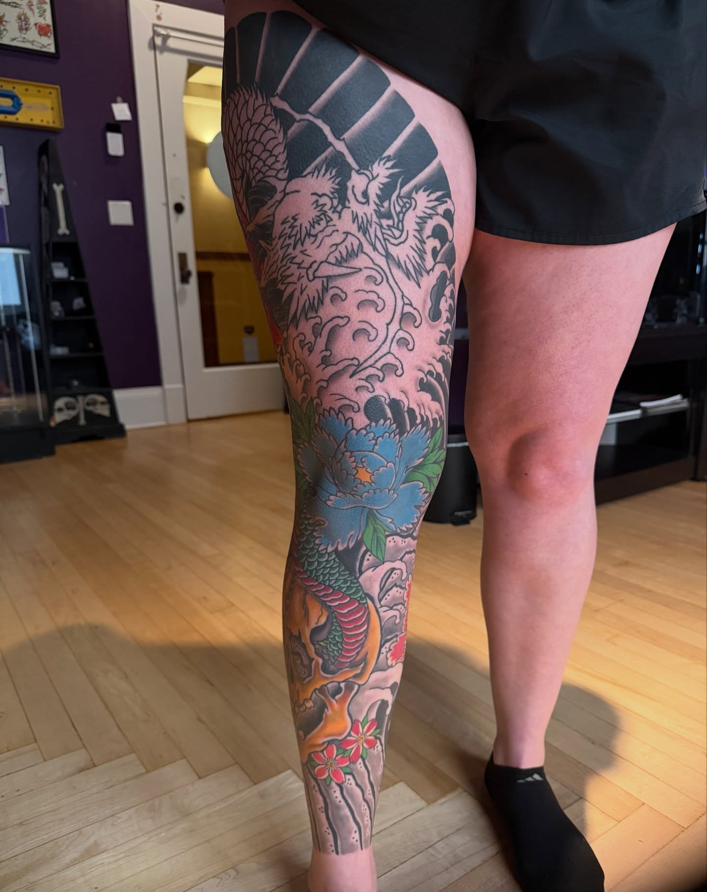 Dragon and peony American traditional tattoo on the leg by Trevor Berry