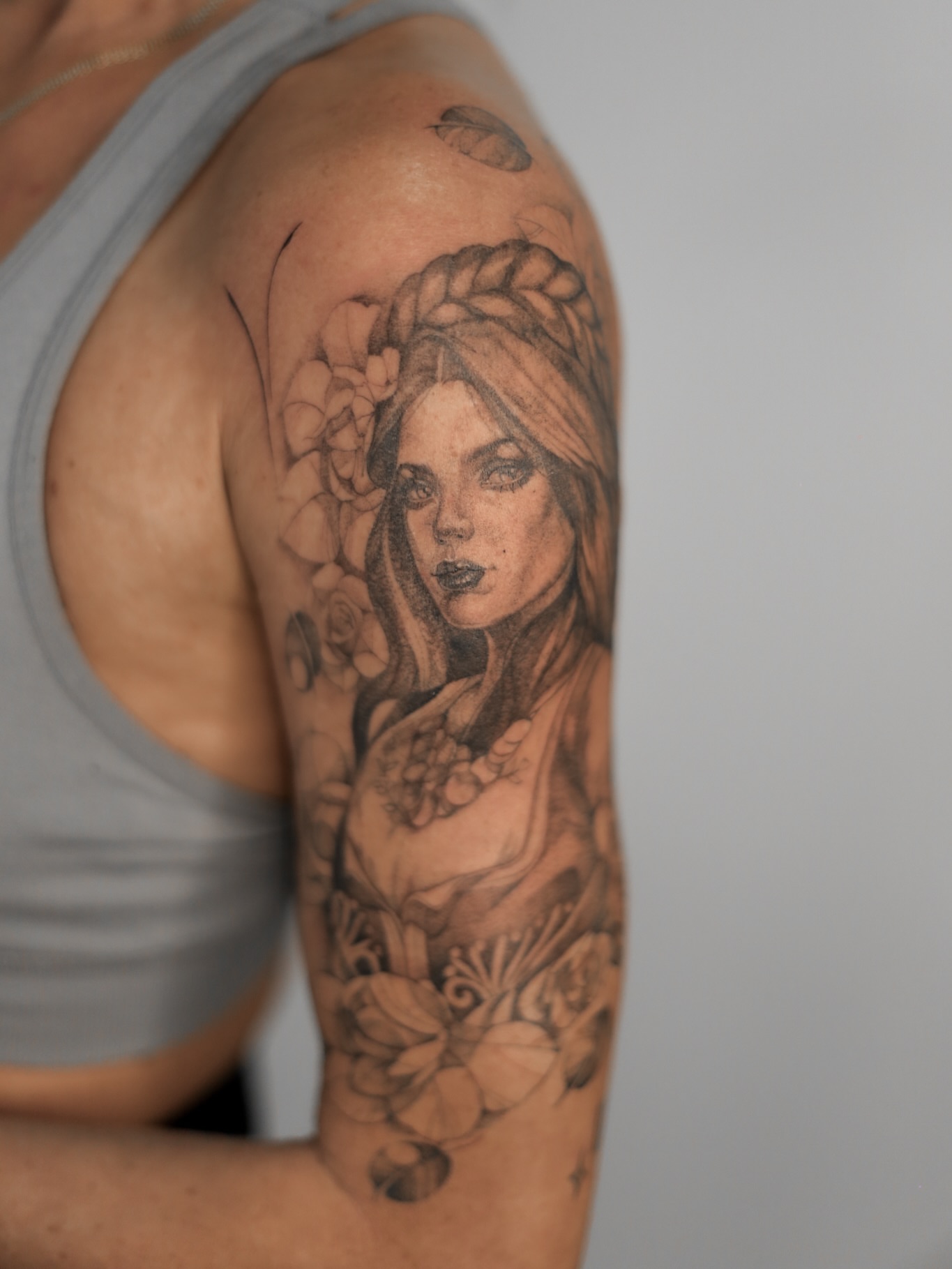 Woman with floral crown realism tattoo on the shoulder by Inna Petrova, Kitchener, Ontario