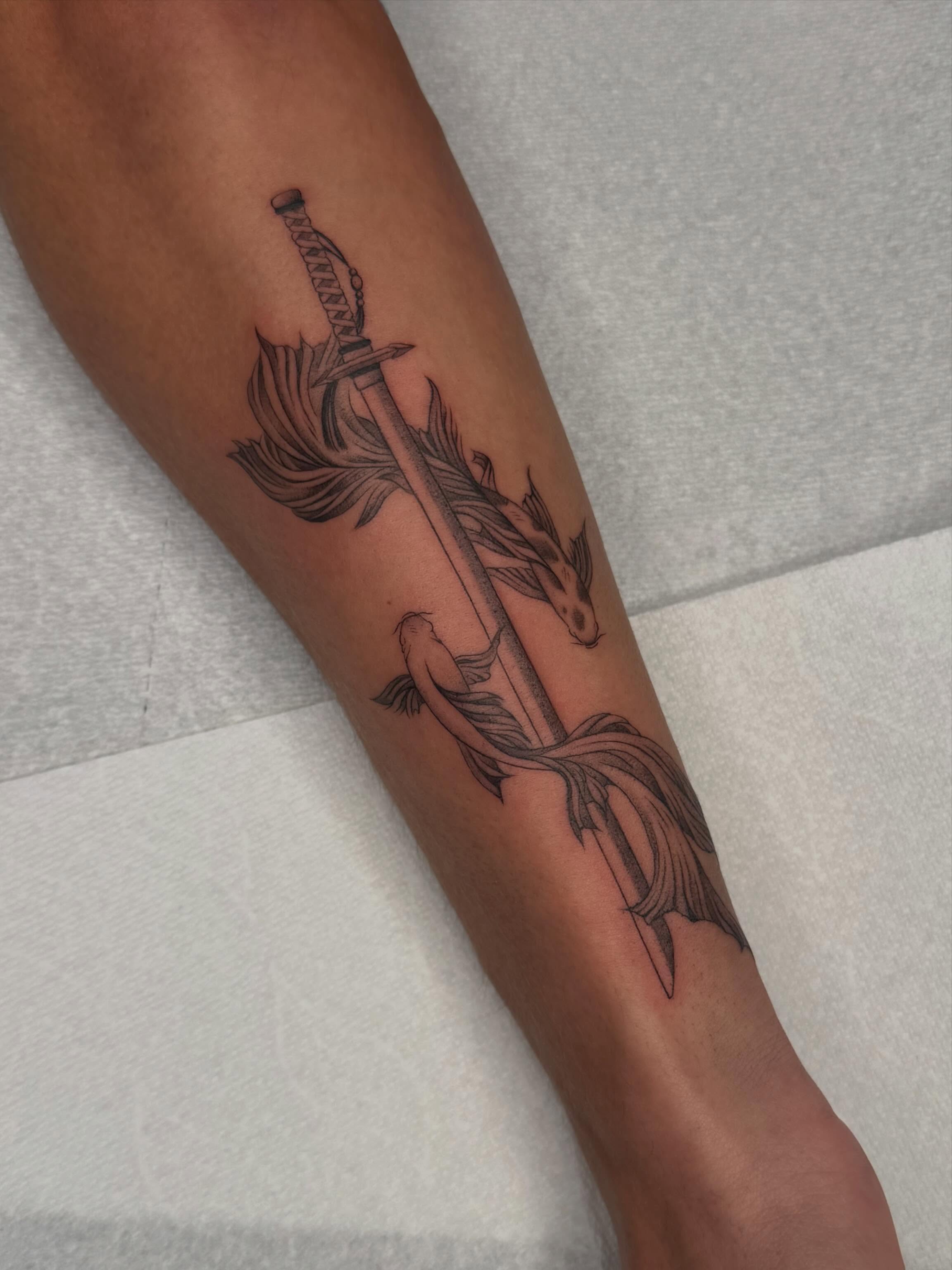 Sword and fish black and grey tattoo on the forearm by Nayoung, San Francisco, California