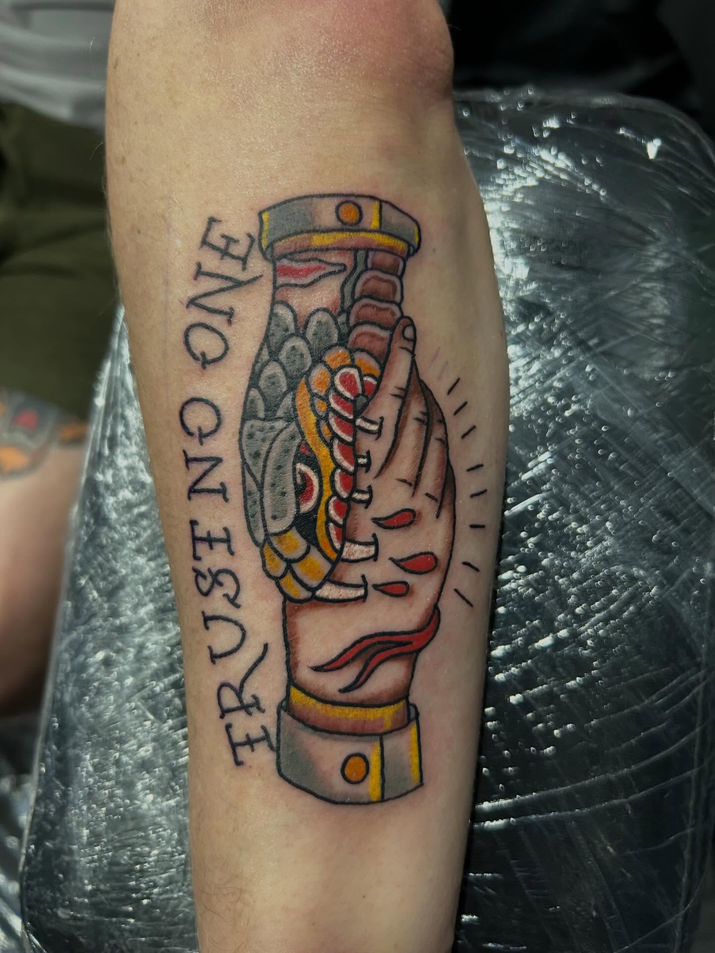 Hand with glove American traditional tattoo on the forearm by Cyko Hernandez