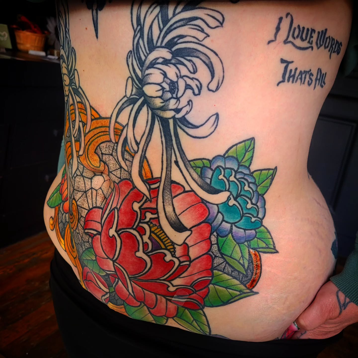 Floral arrangement American traditional tattoo on the ribs by Ashley Thomas, Midvale, Utah