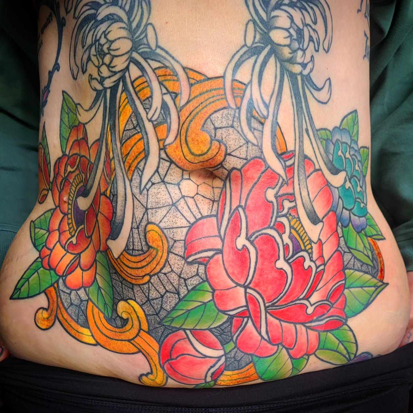 Floral arrangement American traditional tattoo on the torso by Ashley Thomas, Midvale, Utah