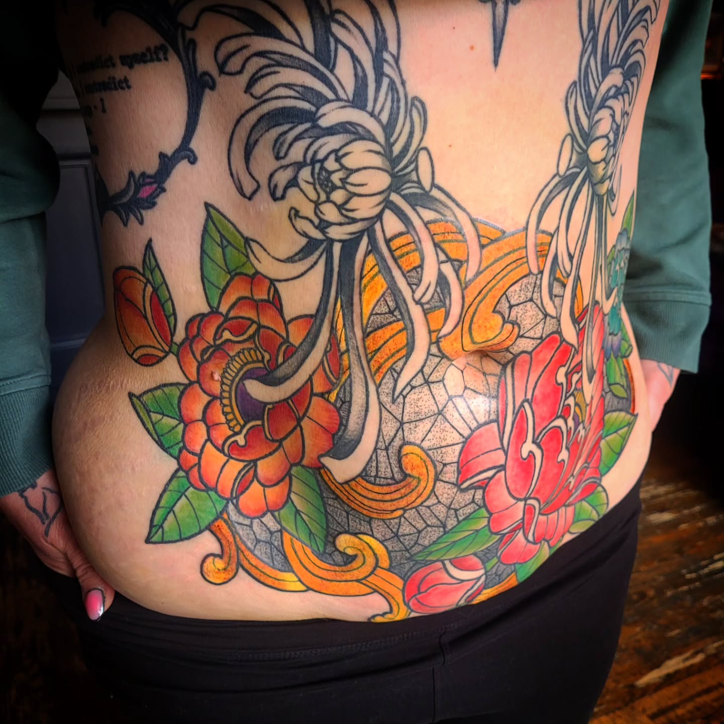 Floral arrangement American traditional tattoo on the torso by Ashley Thomas, Midvale, Utah